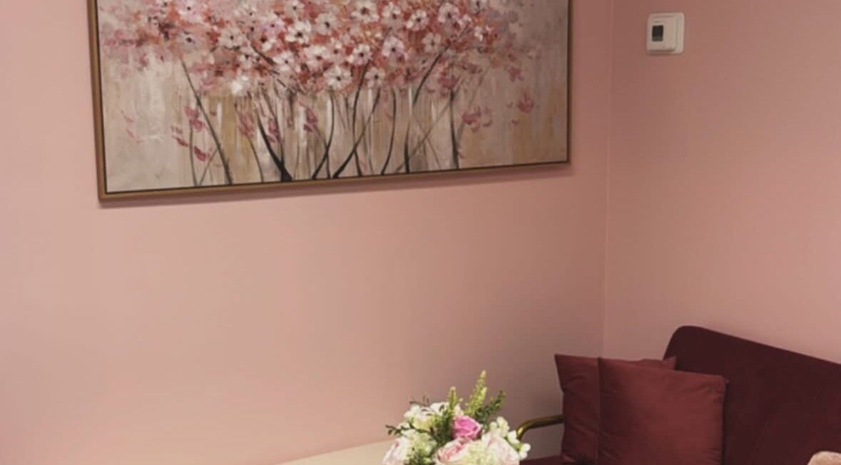 Elegant pink lounge with floral art at Dyosa Beauty and Wellness Lounge, Hamilton, Ontario, CA.