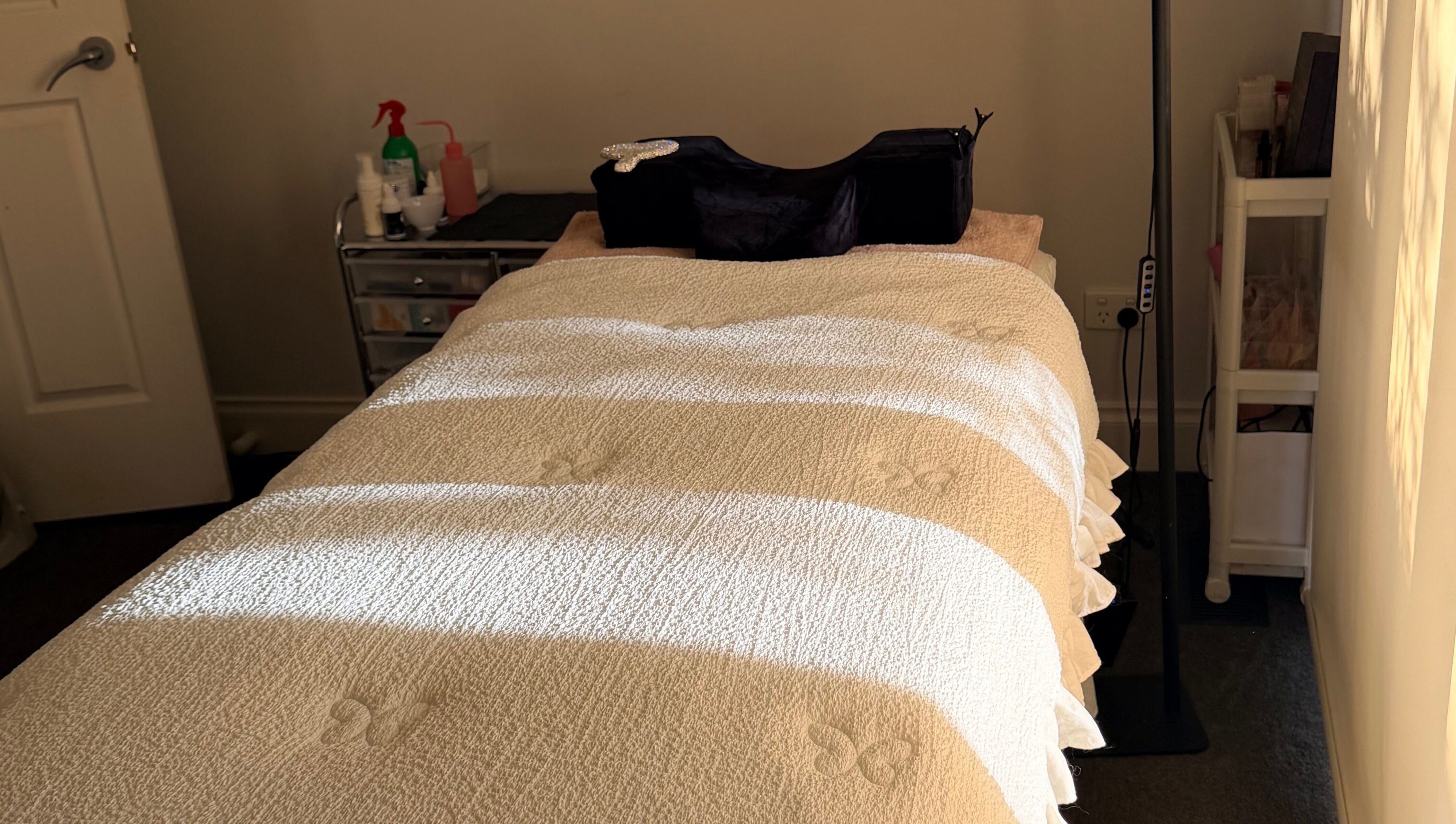 Massage bed at Beauchi & Co, Melbourne, Victoria, AU, bathed in warm sunlight for ultimate relaxation.