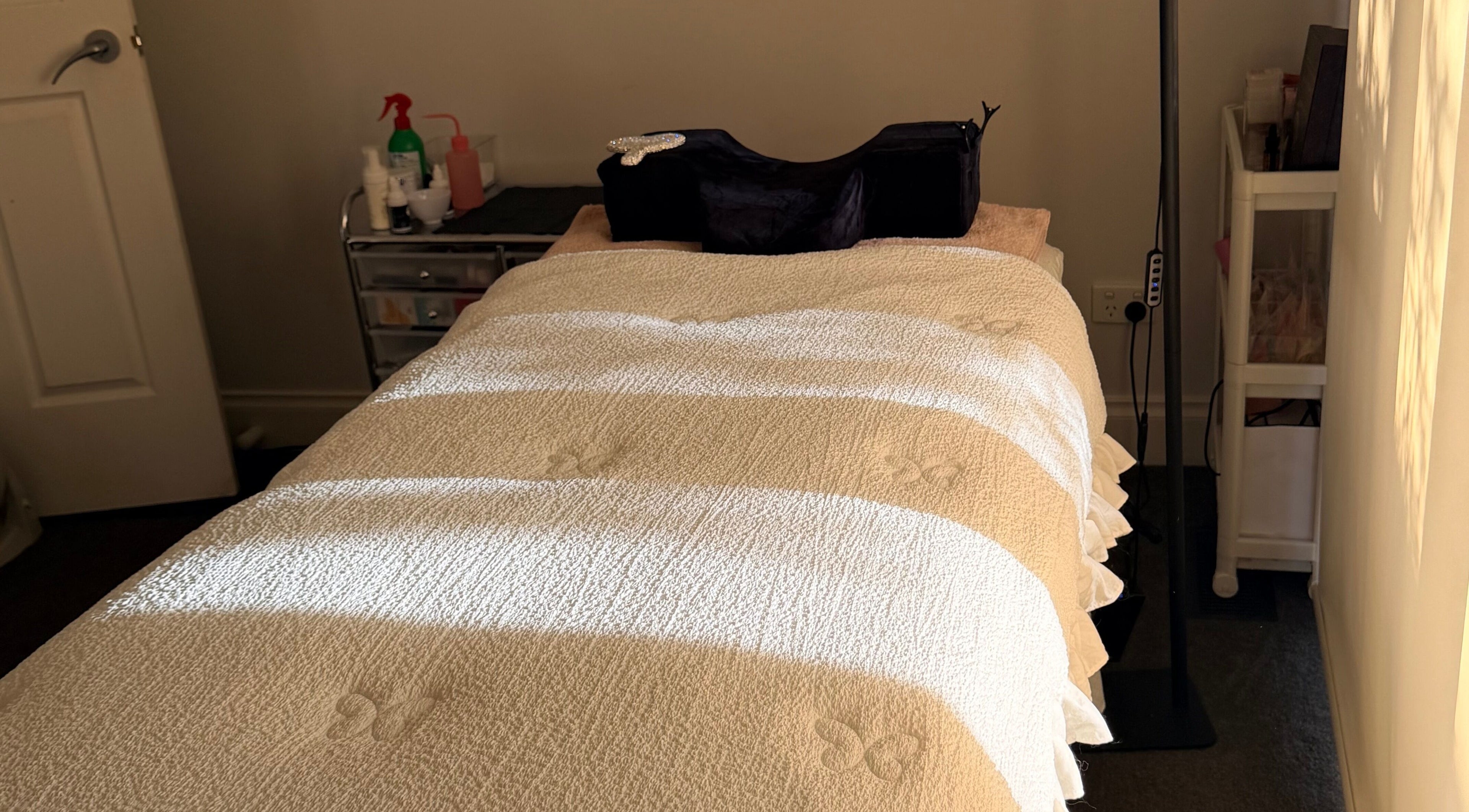 Massage bed at Beauchi & Co, Melbourne, Victoria, AU, bathed in warm sunlight for ultimate relaxation.