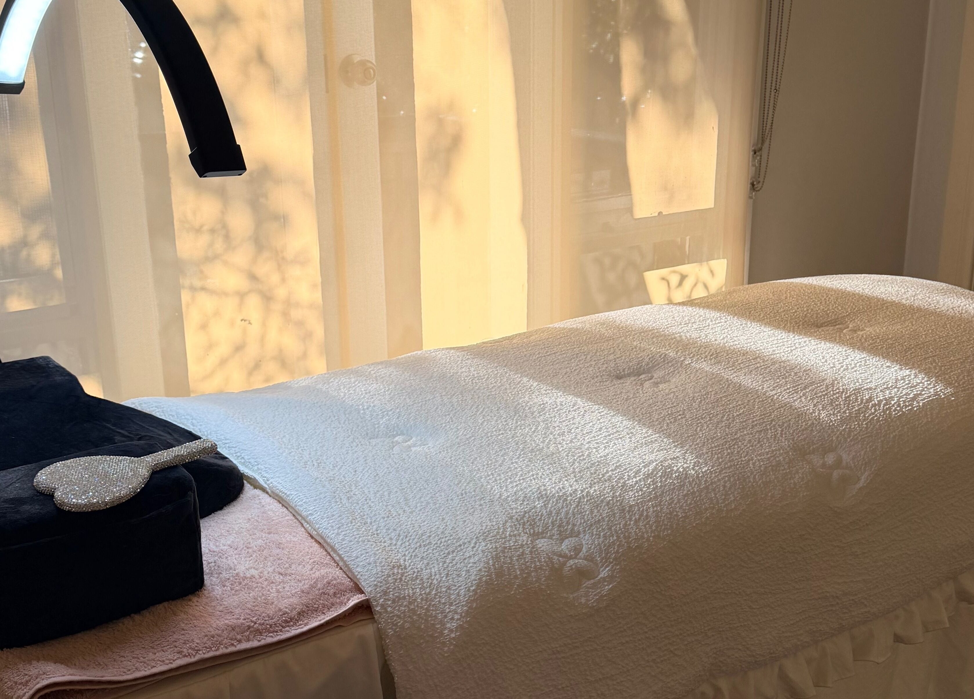 Relaxing treatment bed at Beauchi & Co, Melbourne, Victoria, AU with soft lighting and cozy atmosphere.