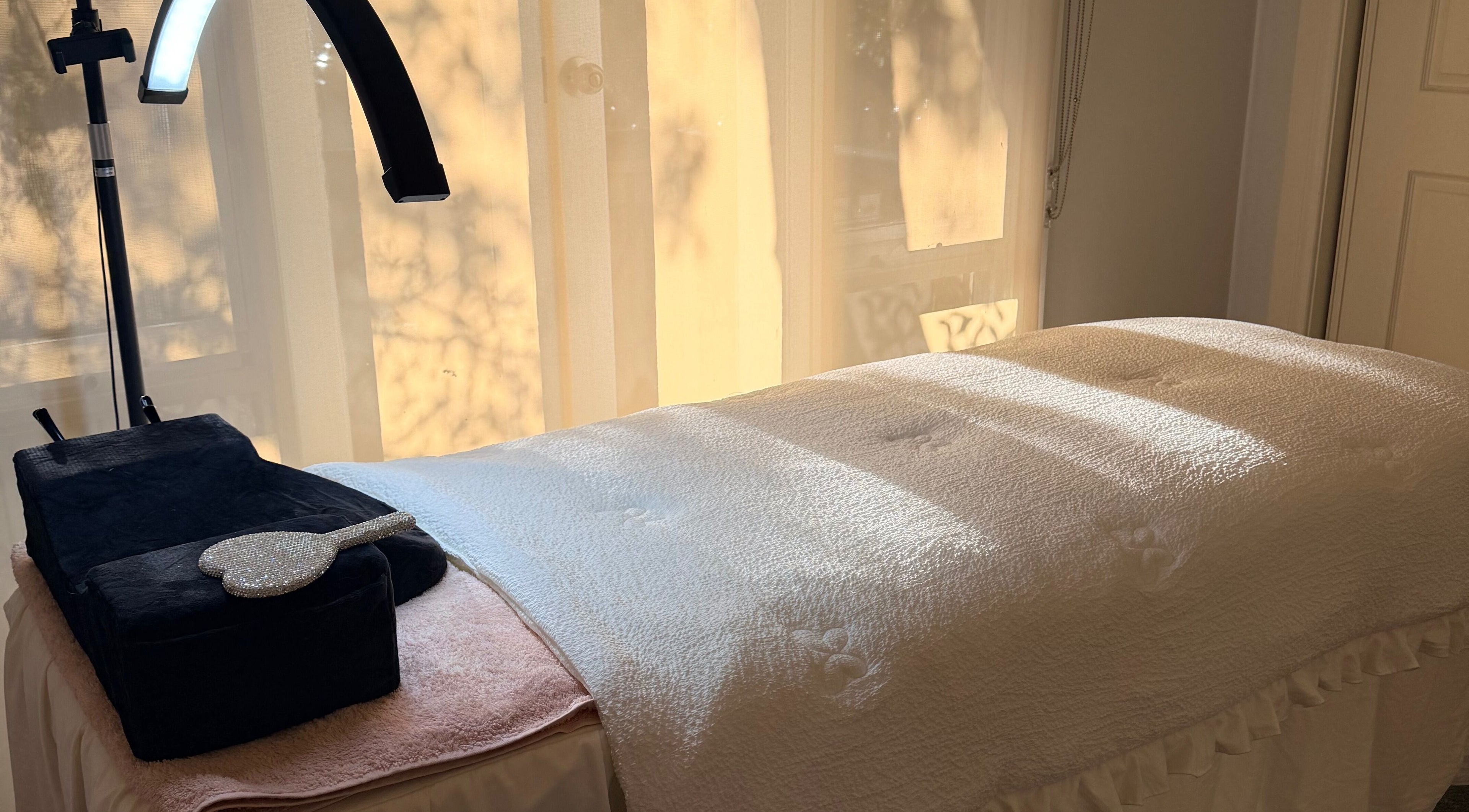 Relaxing treatment bed at Beauchi & Co, Melbourne, Victoria, AU with soft lighting and cozy atmosphere.