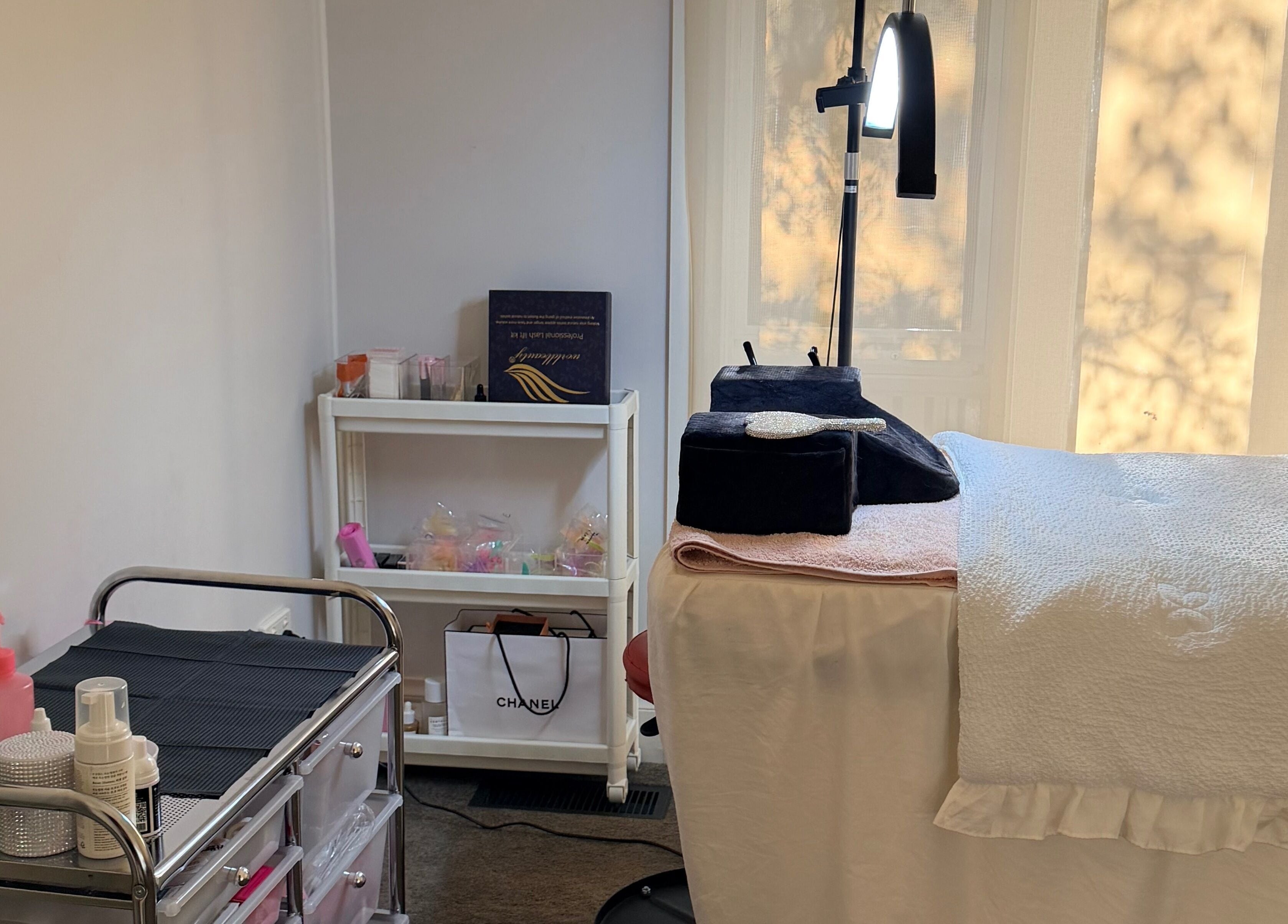Calming spa room at Beauchi & Co, Melbourne, Victoria, AU with a massage table and beauty products.