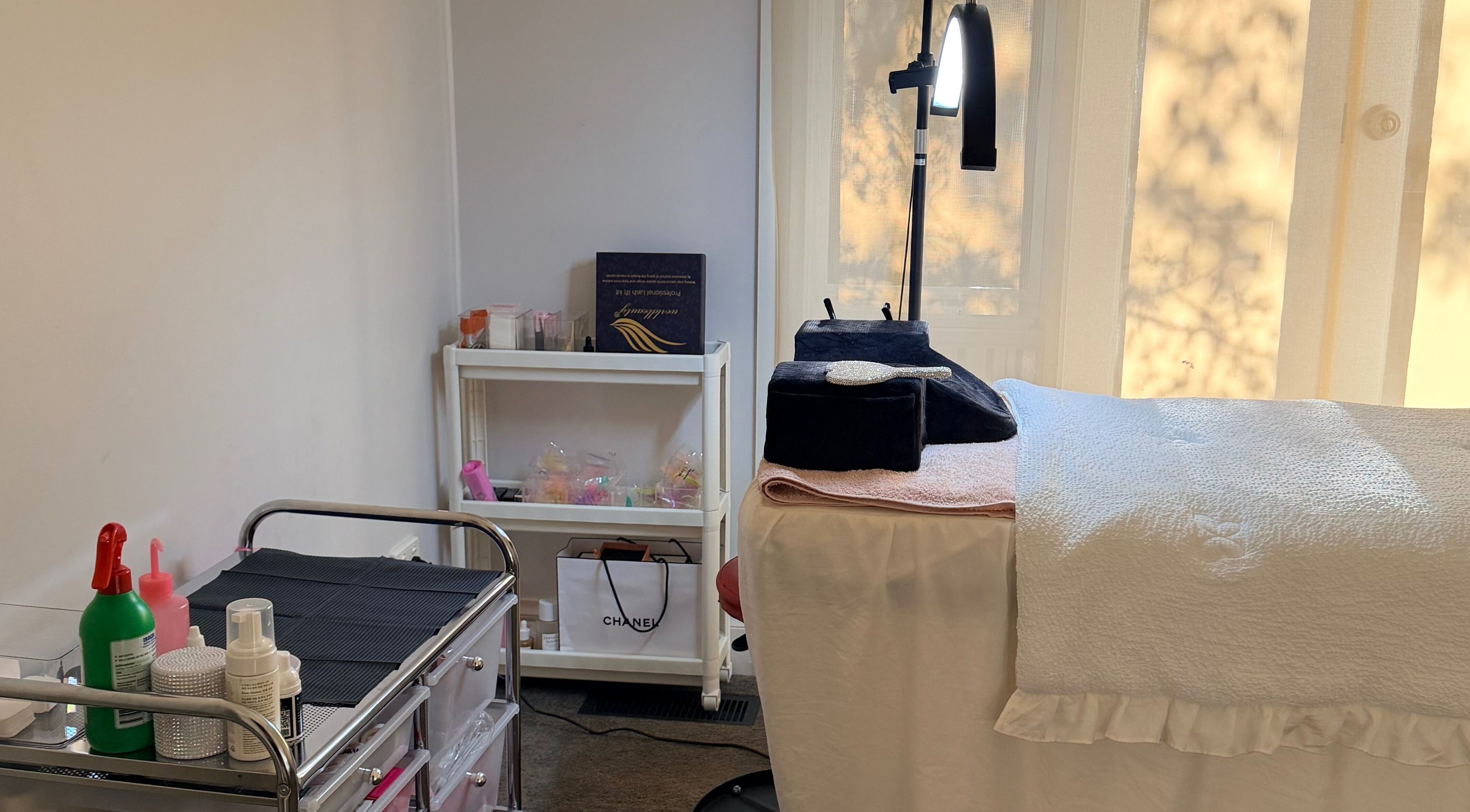Calming spa room at Beauchi & Co, Melbourne, Victoria, AU with a massage table and beauty products.