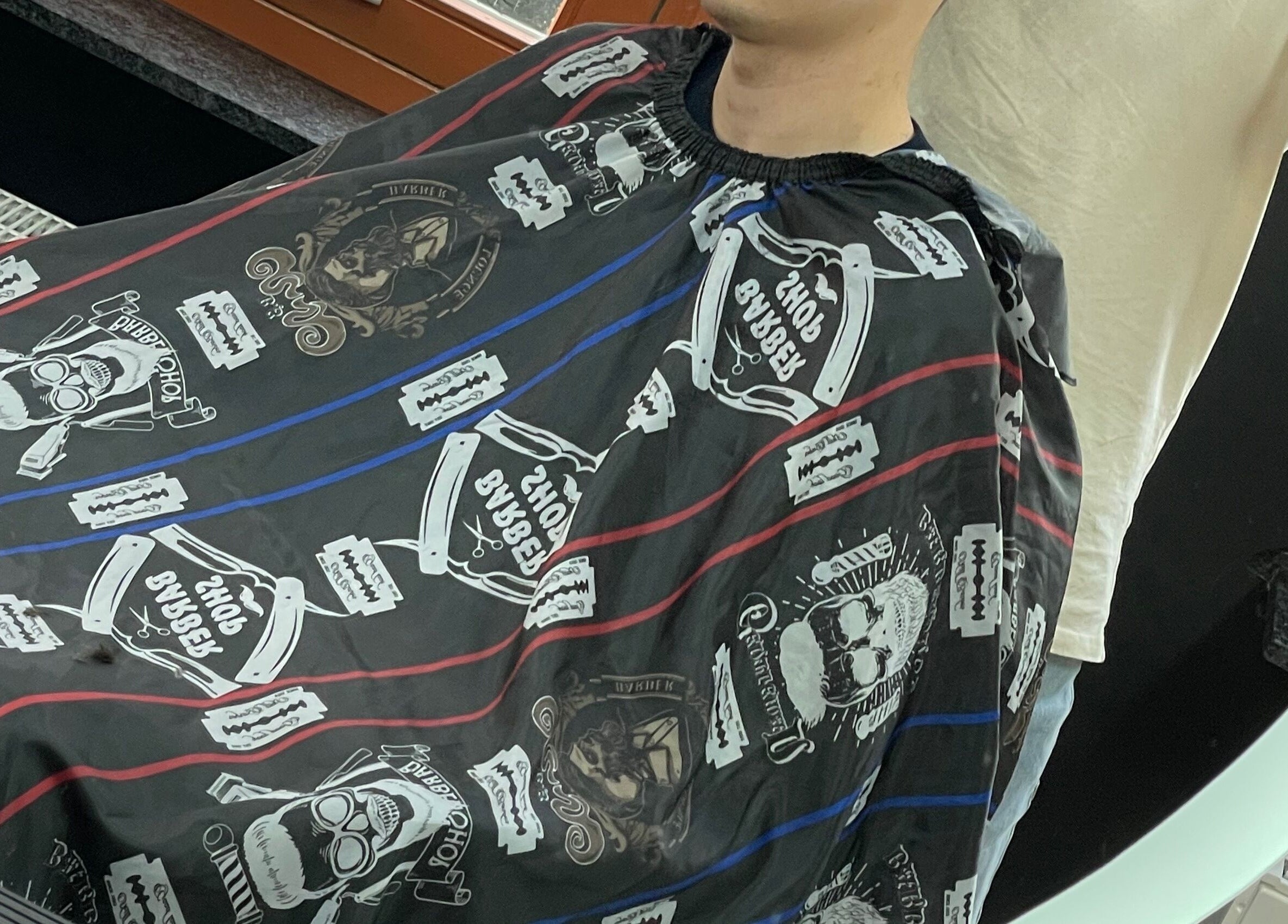 Client wearing a vintage cape at Fade Culture Barbershop, Mosta, MT, ready for a haircut.