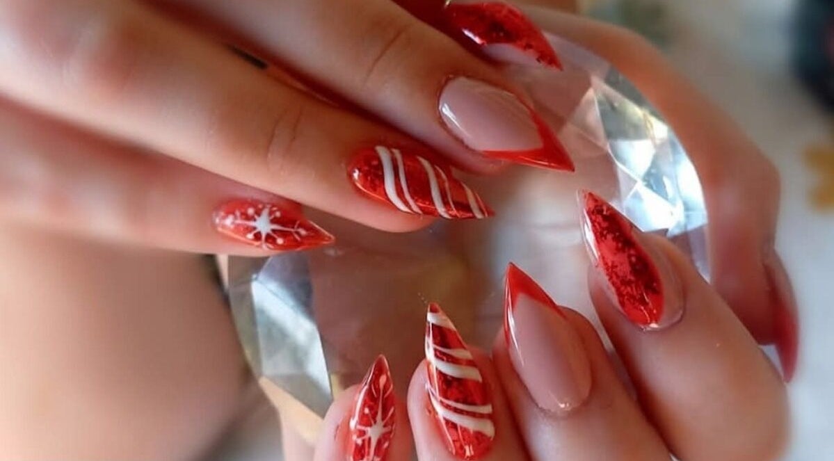 Stunning red nail artistry at THE CUTICLE CONNECTION NEW, Alberton, Gauteng, ZA, showcasing intricate designs.