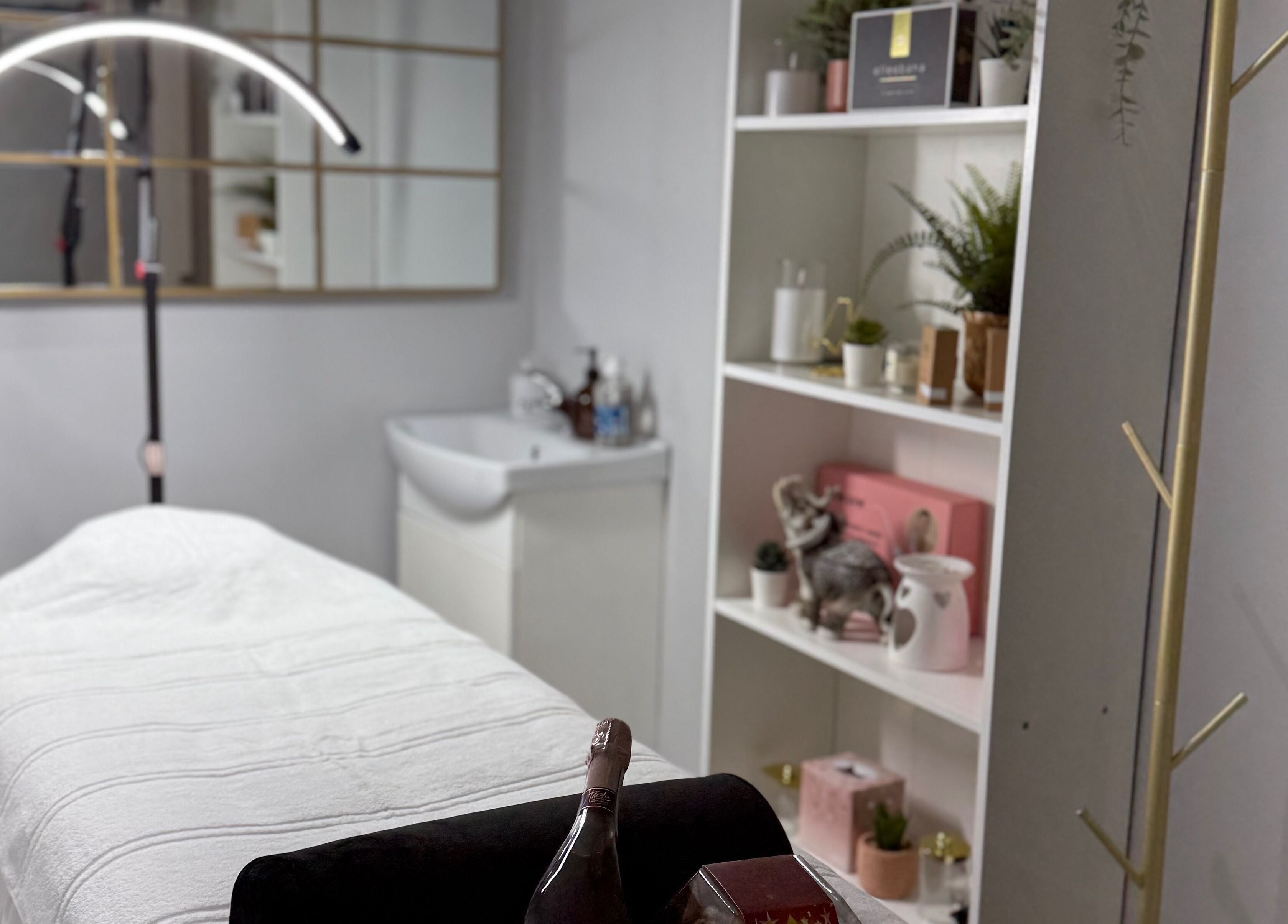 Relaxing treatment room at SkinSociety, Sutton, England, GB, featuring a cozy bed and serene decor.