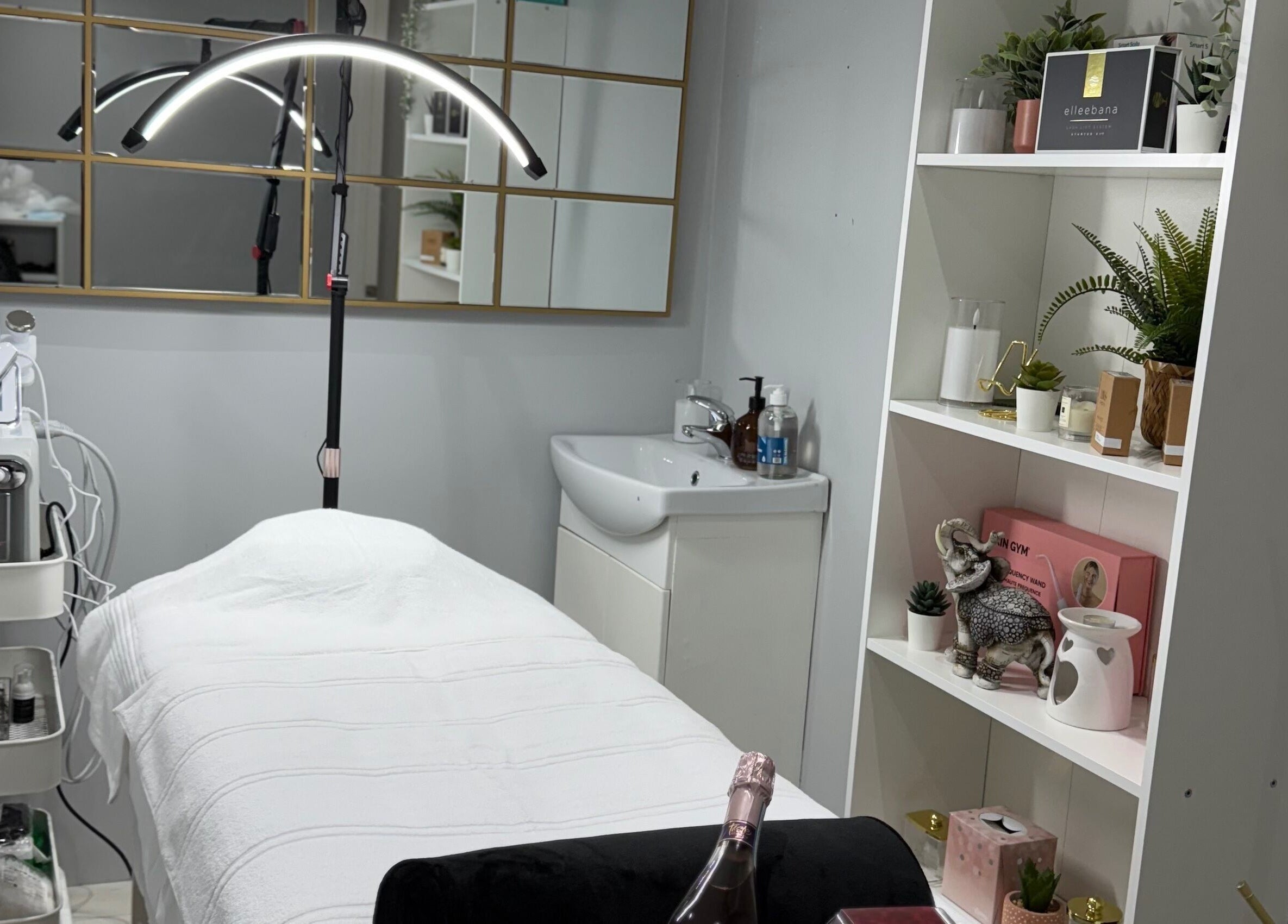 Elegant treatment room at SkinSociety, Sutton, England, GB, showcasing a spa bed and beauty equipment.