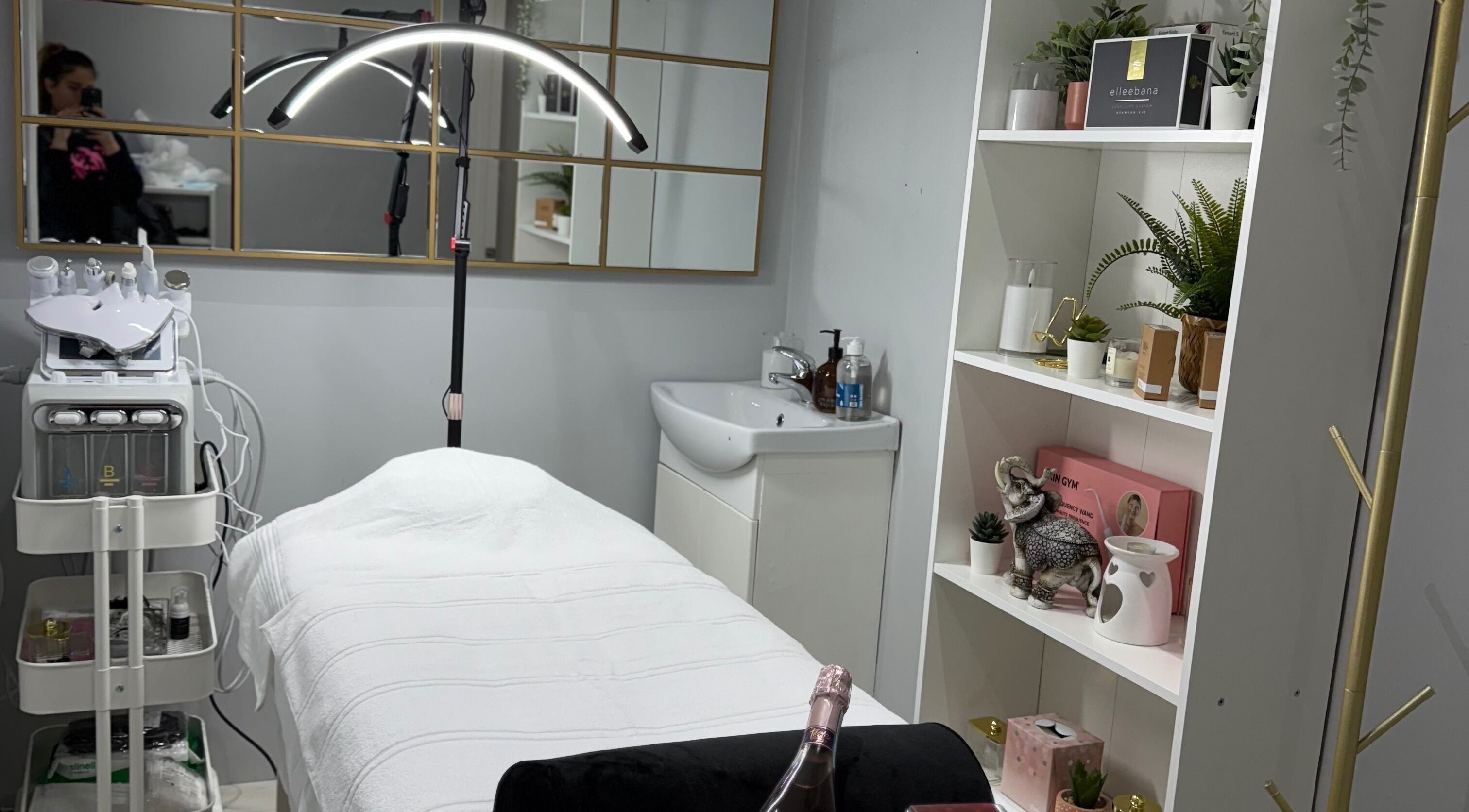 Elegant treatment room at SkinSociety, Sutton, England, GB, showcasing a spa bed and beauty equipment.
