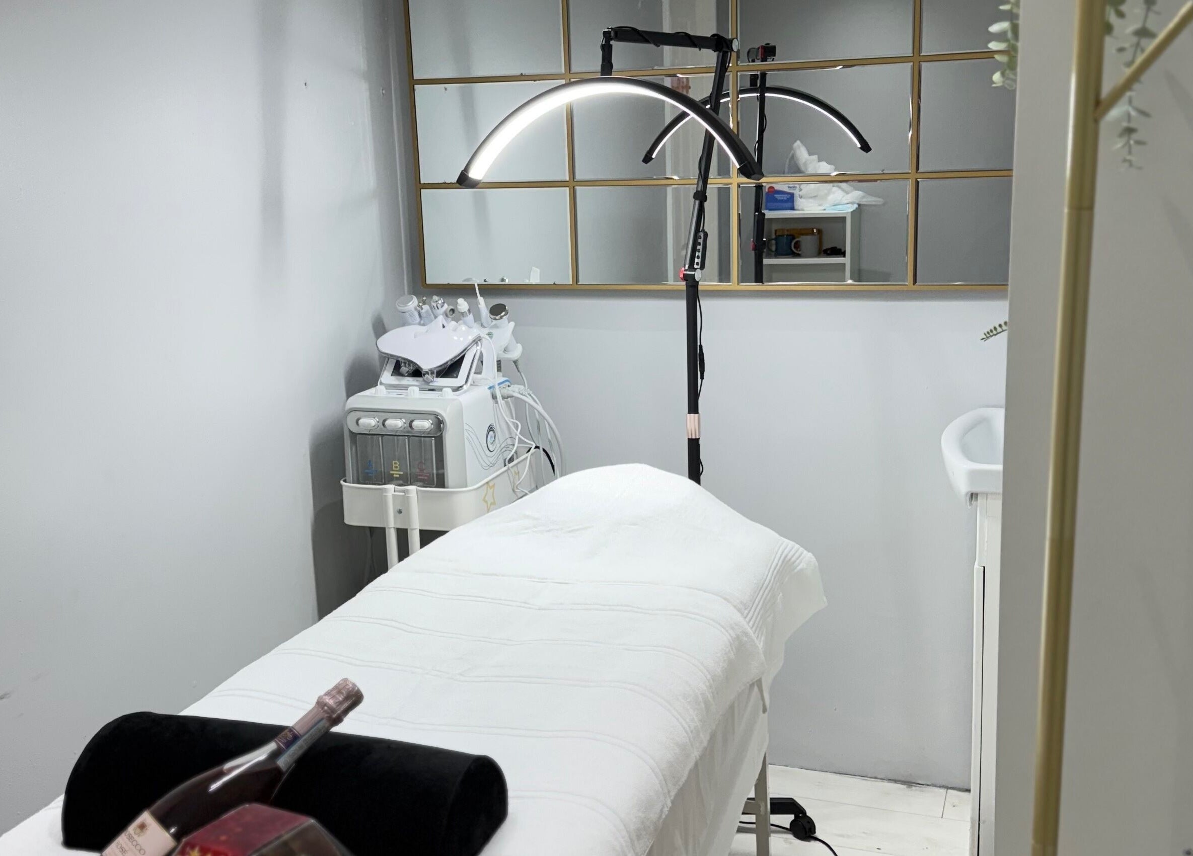 Relaxing treatment room at SkinSociety, Sutton, England, GB, with modern equipment and a serene atmosphere.