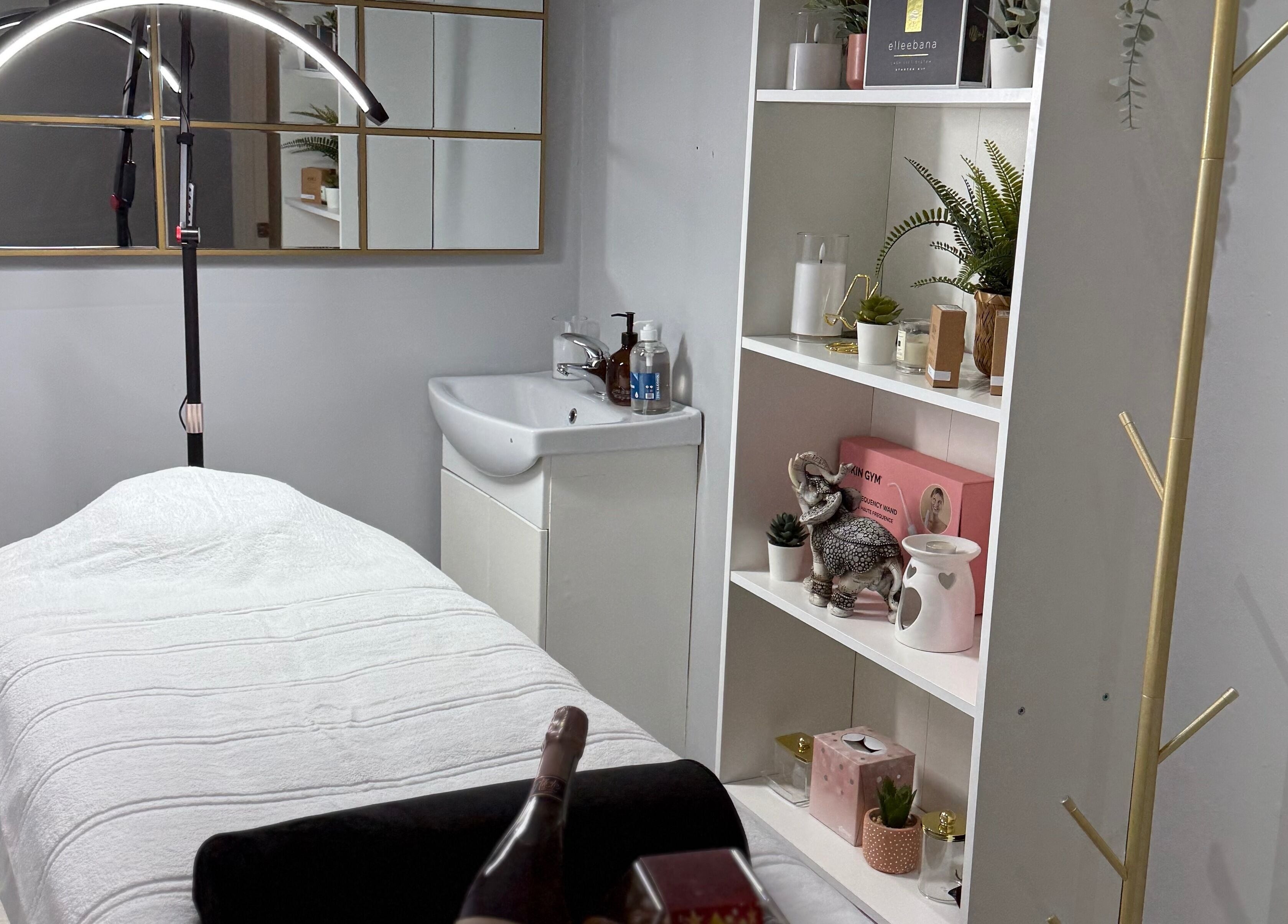 Relaxing treatment room at SkinSociety, Sutton, England, GB with a cozy bed and elegant decor.