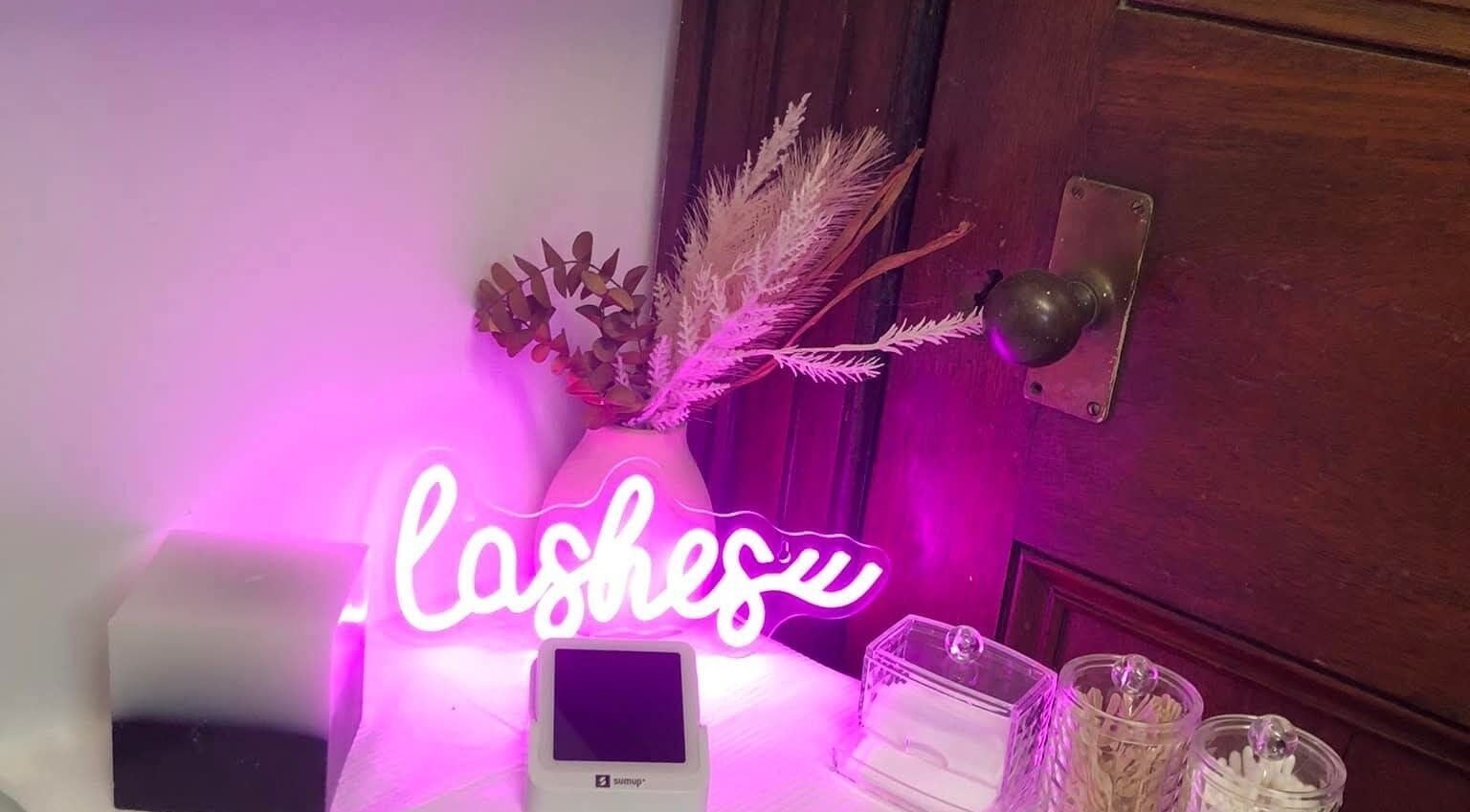 Prettylittle beauty's vibrant lash display with neon sign in Pembroke, Wales, GB enhancing ambiance.