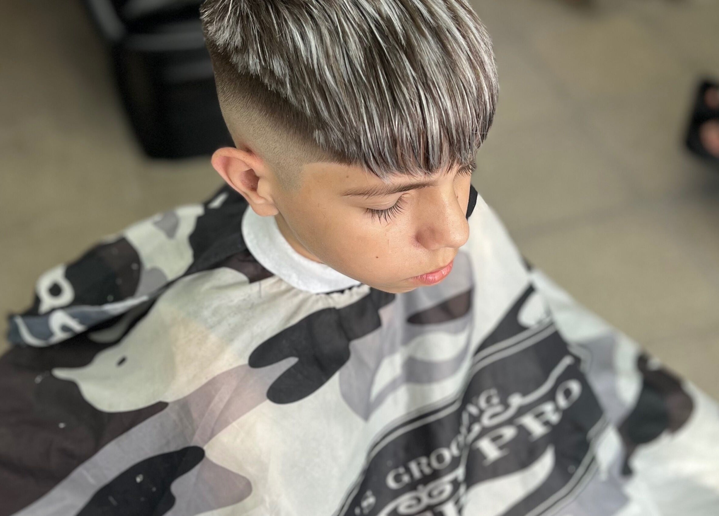 Young boy with a trendy haircut at Yuyi barber, Lomas Del Mirador, Provincia De Buenos Aires, AR.