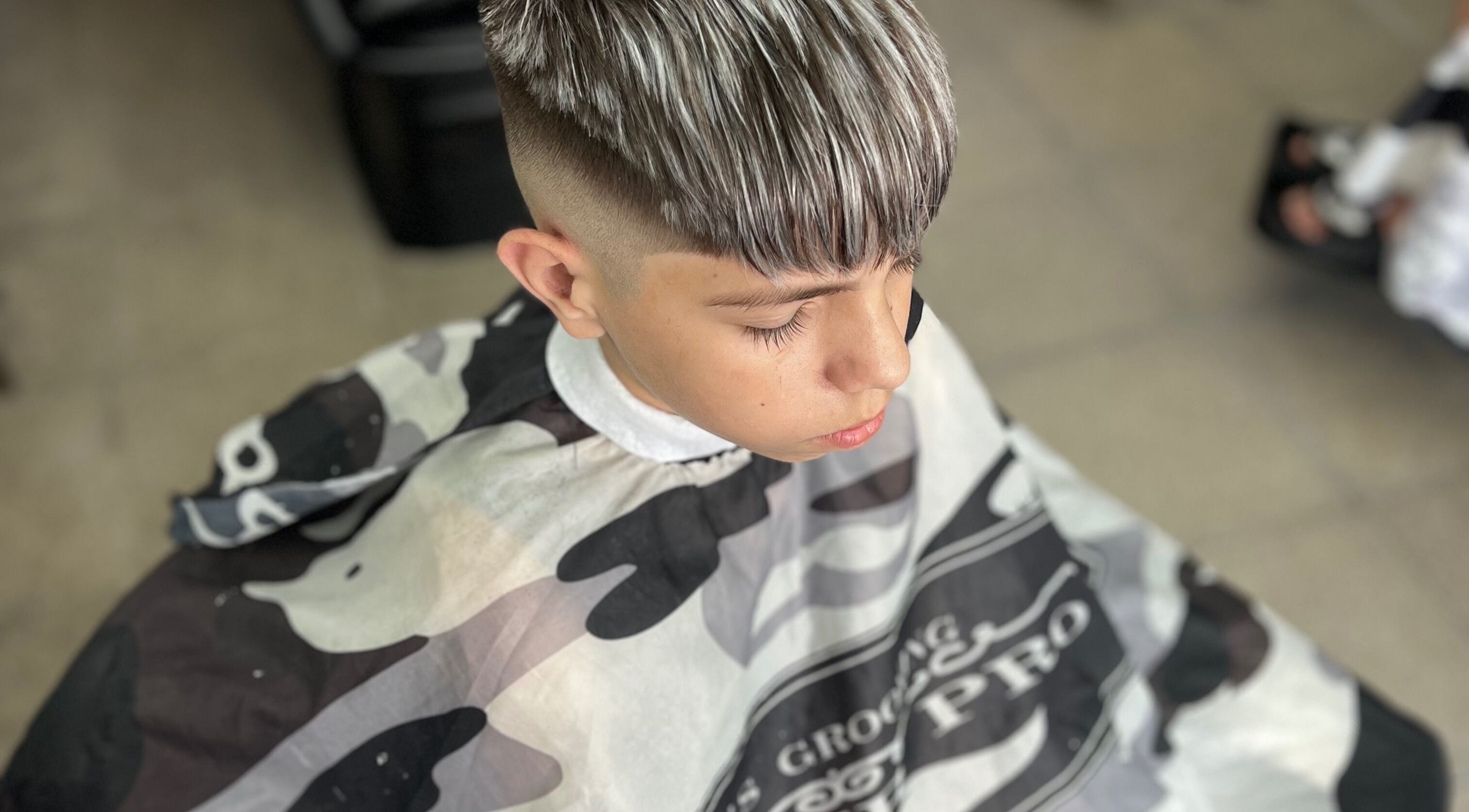Young boy with a trendy haircut at Yuyi barber, Lomas Del Mirador, Provincia De Buenos Aires, AR.