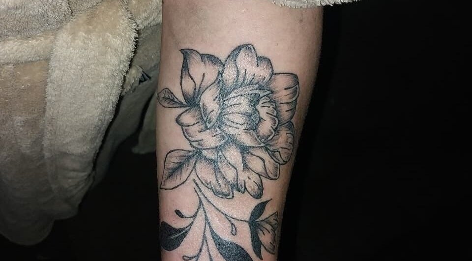 Floral tattoo design by Tattoo with Khalifa Inc. in George, Western Cape, ZA highlights intricate artistry.