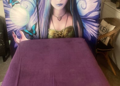 Purple treatment table at Healing Hands, Weston-super-mare, England, GB, with ethereal artwork in the background.
