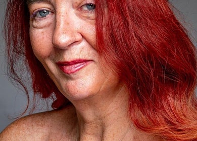 A confident woman at Healing Hands, Weston-super-Mare, England, GB, showcasing vibrant red hair.