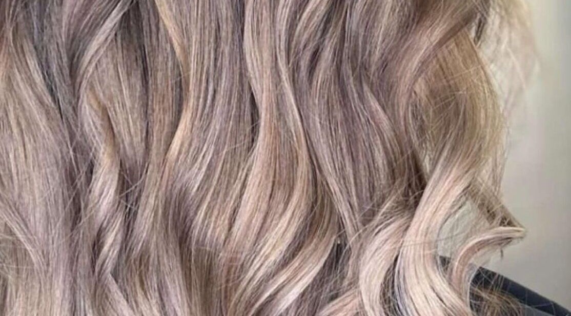 Blonde wavy hair styled at Enhance Studio, Leeds, England, GB. Perfect for a glamorous look.