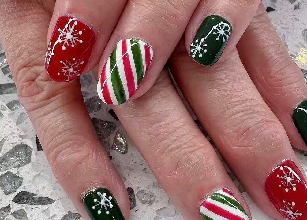 Holiday-themed nail art in red, green, white at YOYO NAILS, Noblesville, Indiana, US.