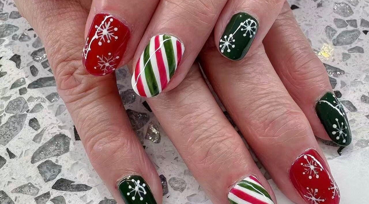Holiday-themed nail art in red, green, white at YOYO NAILS, Noblesville, Indiana, US.