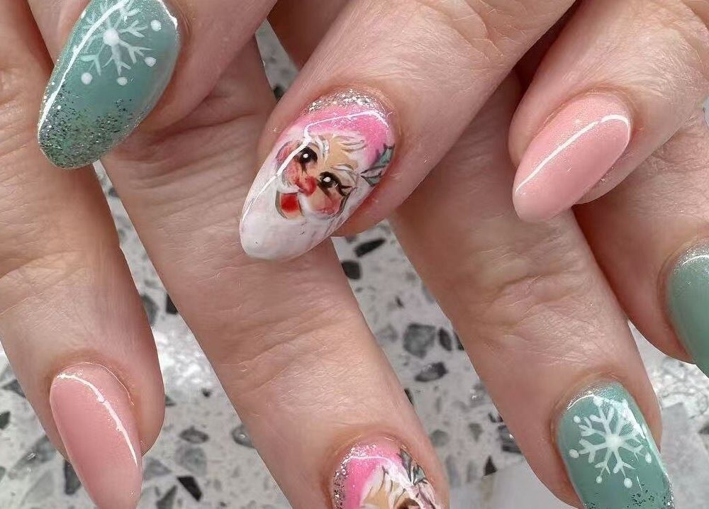 Festive nail art with snowflake and Santa design at YOYO NAILS, Noblesville, Indiana, US.