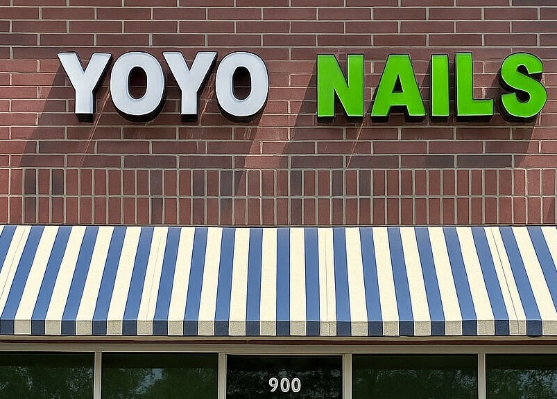 Front view of YOYO NAILS with striped awning in Noblesville, Indiana, US.