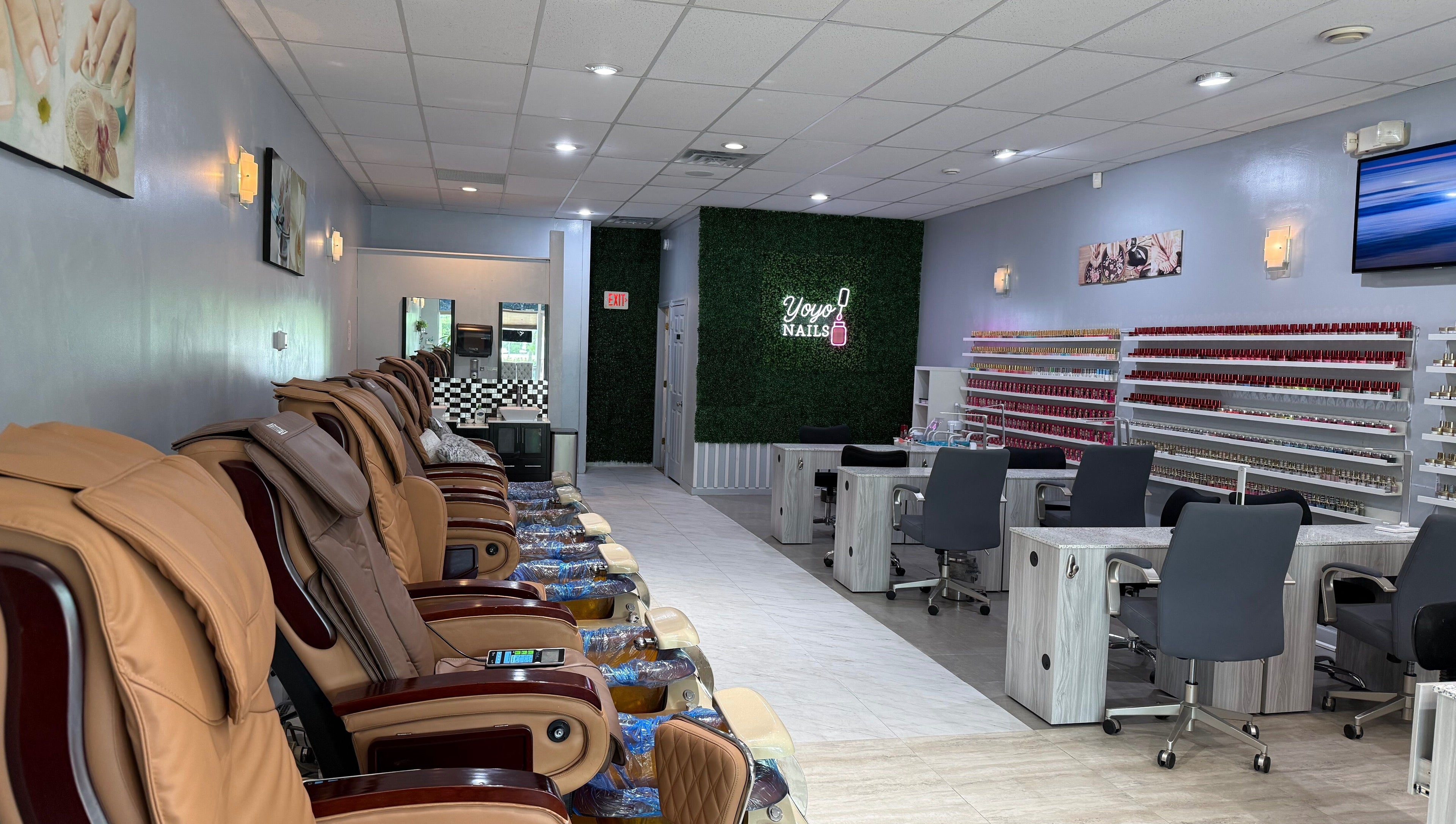 Interior of Yoyo Nails in Noblesville, Indiana showcasing massage chairs and nail polish racks.
