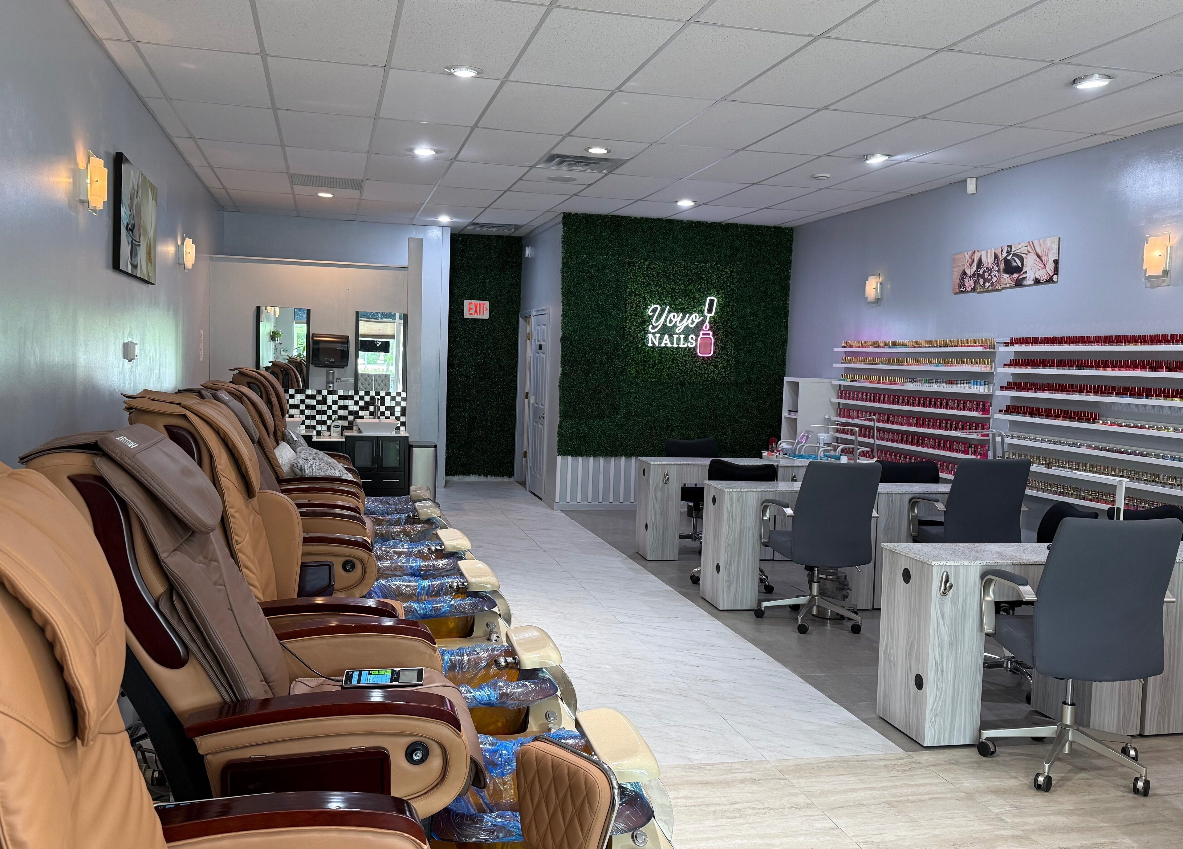 Interior of Yoyo Nails in Noblesville, Indiana showcasing massage chairs and nail polish racks.