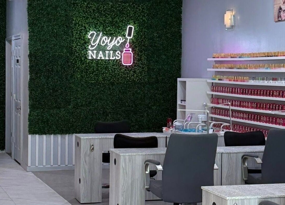 Chic interior of Yoyo Nails in Noblesville, Indiana, US featuring manicure stations and colorful polish wall.