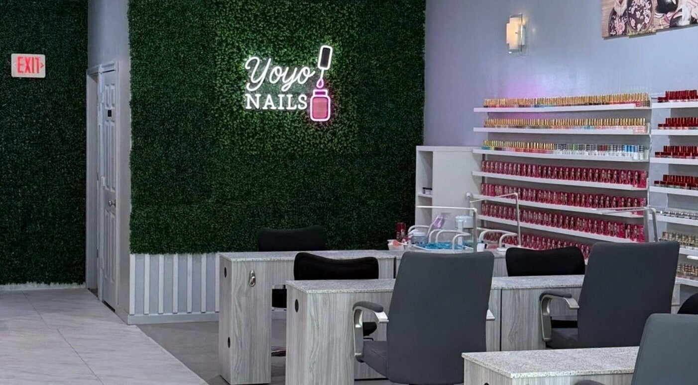 Chic interior of Yoyo Nails in Noblesville, Indiana, US featuring manicure stations and colorful polish wall.