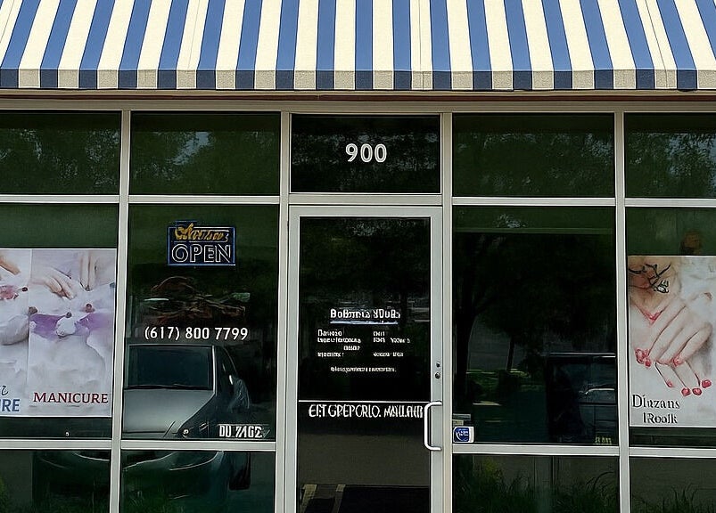 Exterior view of Yoyo Nails, a nail salon in Noblesville, Indiana, US, with striped canopy and glass-front display.