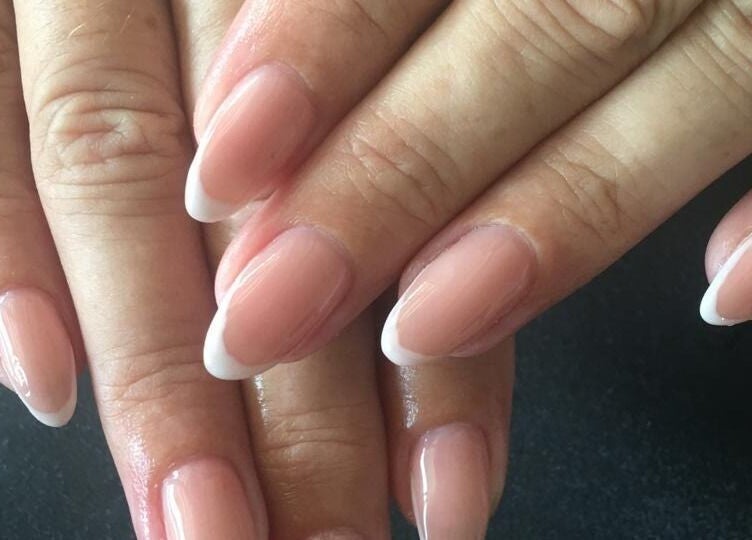 Elegant nude and white French nails at Ongles par flor in Paramaribo, Paramaribo, SR.
