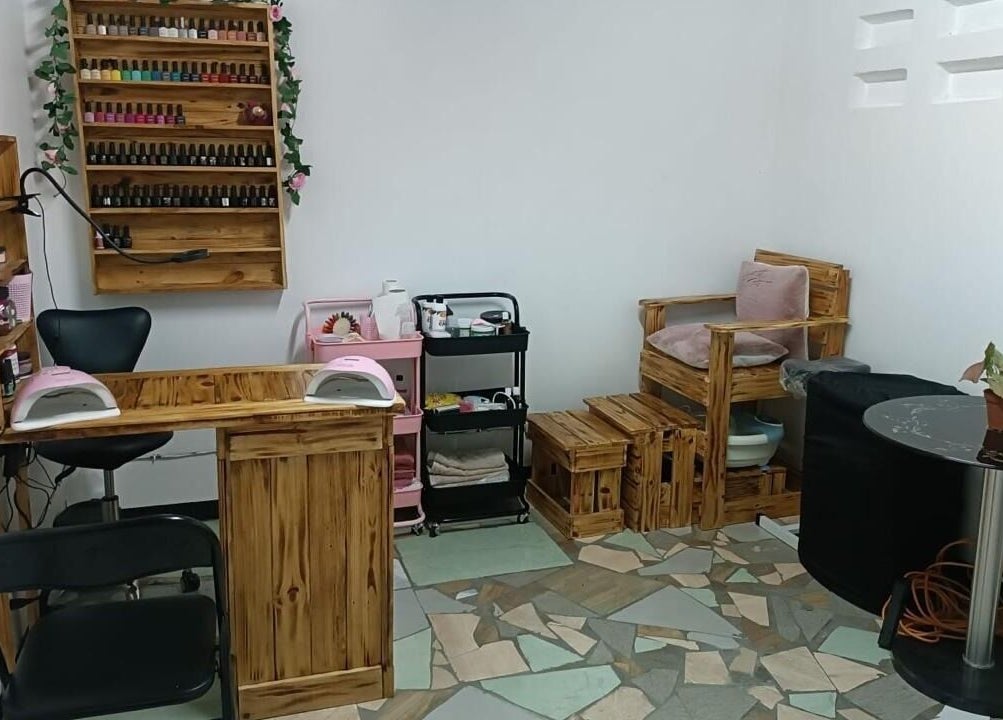 A cozy nail station at Ongles par flor in Paramaribo, Paramaribo, SR featuring wooden furniture and nail polish.