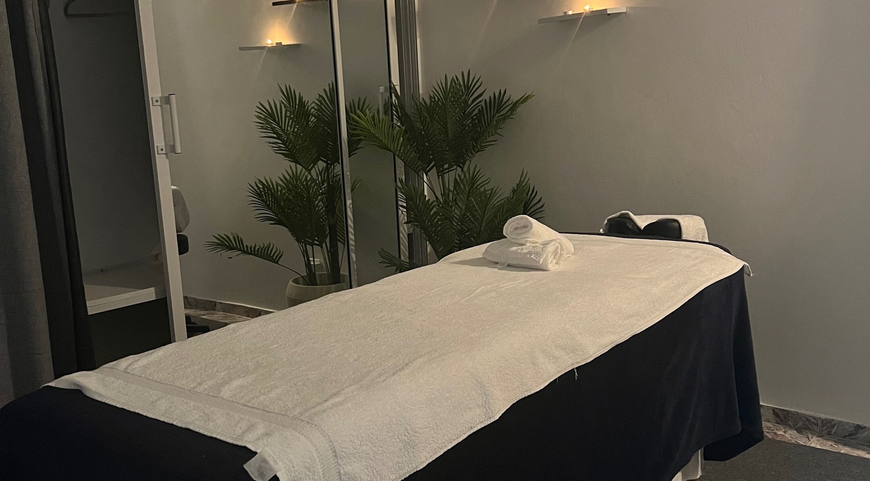Relaxing massage room at Caya Spa, Santiago De Los Caballeros, Santiago, DO with soft candlelight.