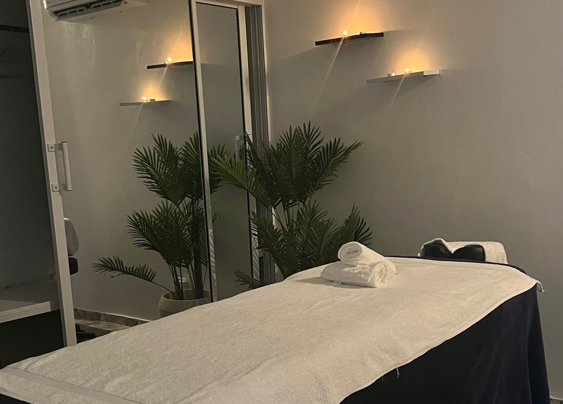 Tranquil massage room at Caya Spa in Santiago De Los Caballeros, Santiago, DO. Calm lighting and cozy setting.