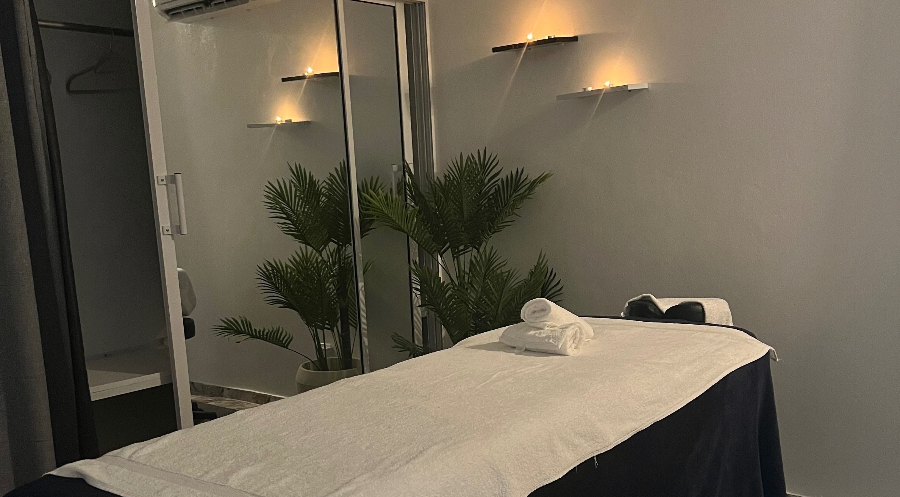 Tranquil massage room at Caya Spa in Santiago De Los Caballeros, Santiago, DO. Calm lighting and cozy setting.