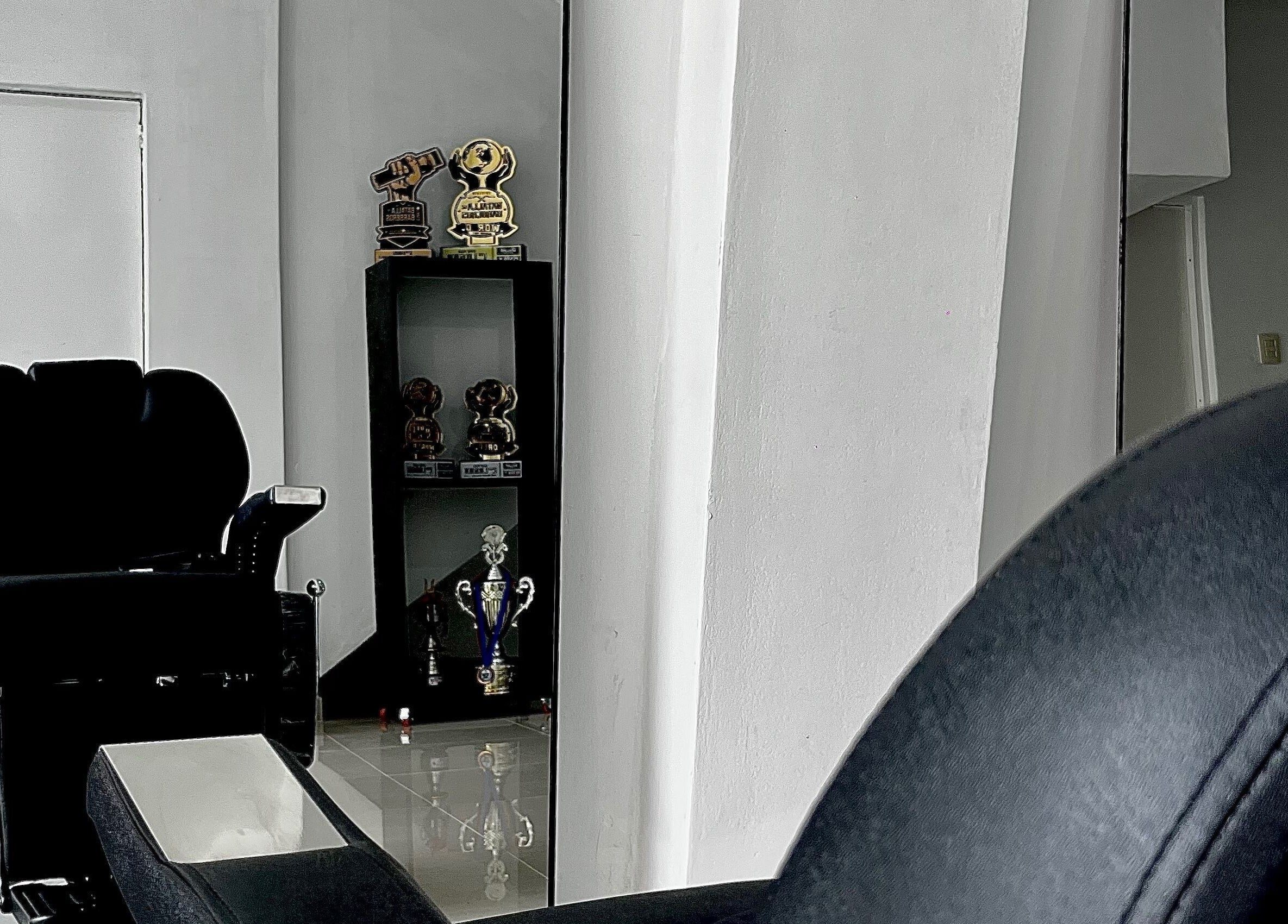 Chic salon chair at HENKO HAIR STUDIO in Chiclayo, Lambayeque, PE with awards in the background.