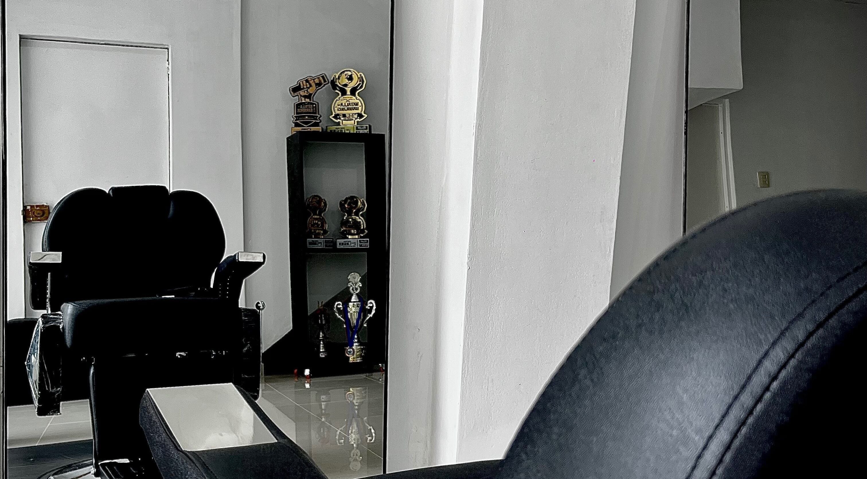 Chic salon chair at HENKO HAIR STUDIO in Chiclayo, Lambayeque, PE with awards in the background.