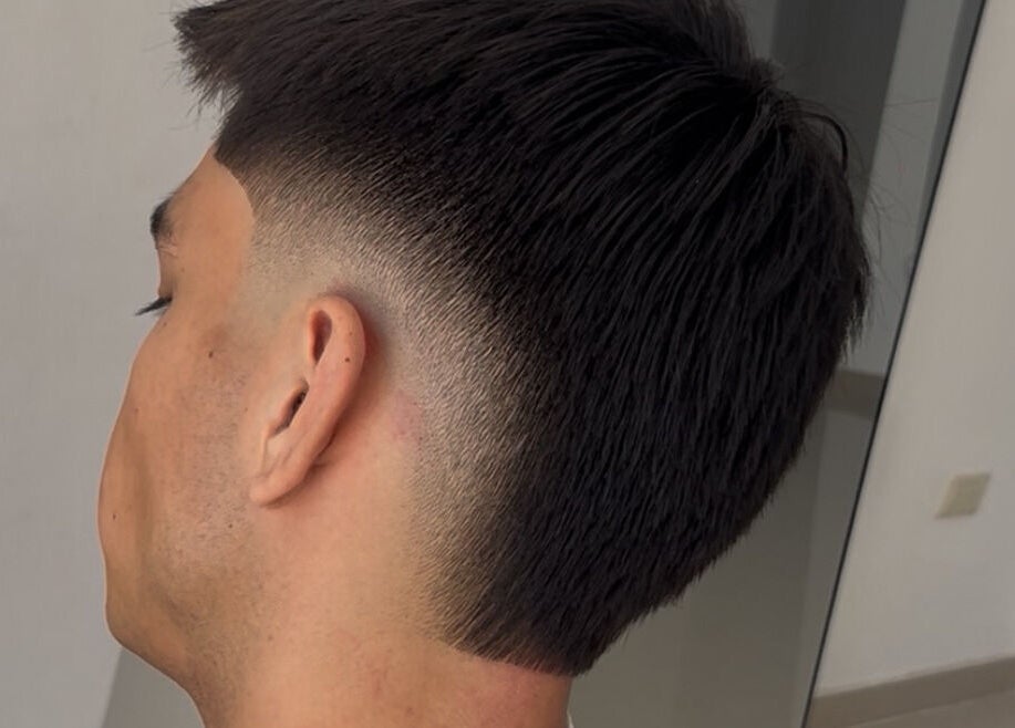 Close-up of a fade haircut at HENKO HAIR STUDIO, Chiclayo, Lambayeque, PE, showcasing precision styling.