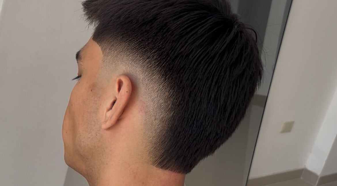 Close-up of a fade haircut at HENKO HAIR STUDIO, Chiclayo, Lambayeque, PE, showcasing precision styling.