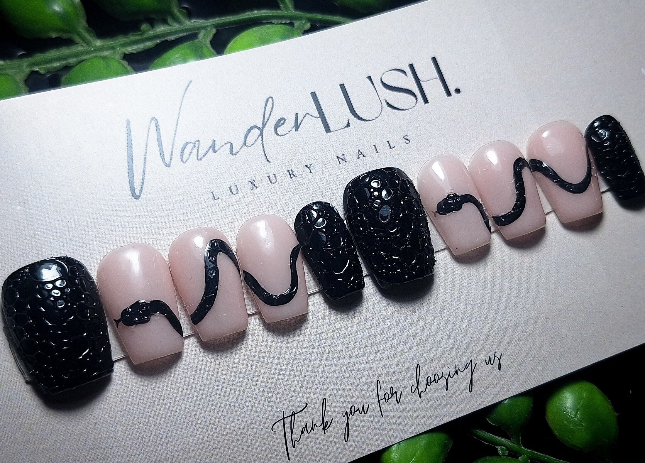 Stylish nail design by WanderLush Beauty Studio in Ballito, Kwazulu-natal, ZA with intricate black patterns.