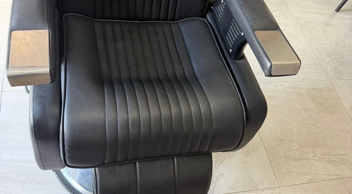 Modern barber chair at Billionaire Barber, Ruby, Saint Philip, BB showcasing style and comfort.