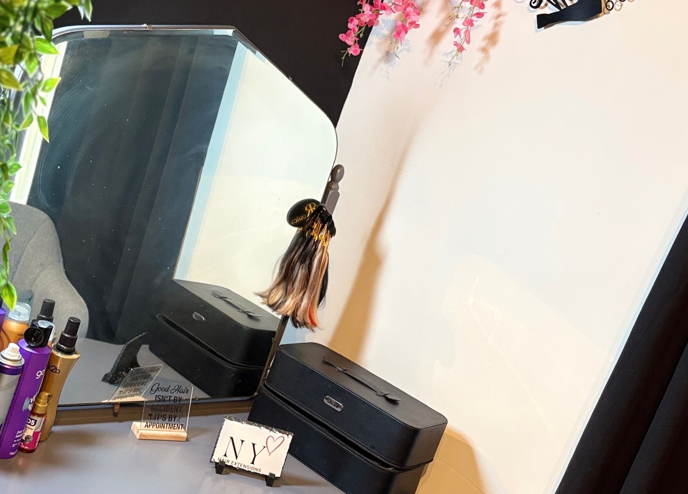 Beauty station at NYHairextensions, Carlisle, England, GB with styling products and mirror decor.