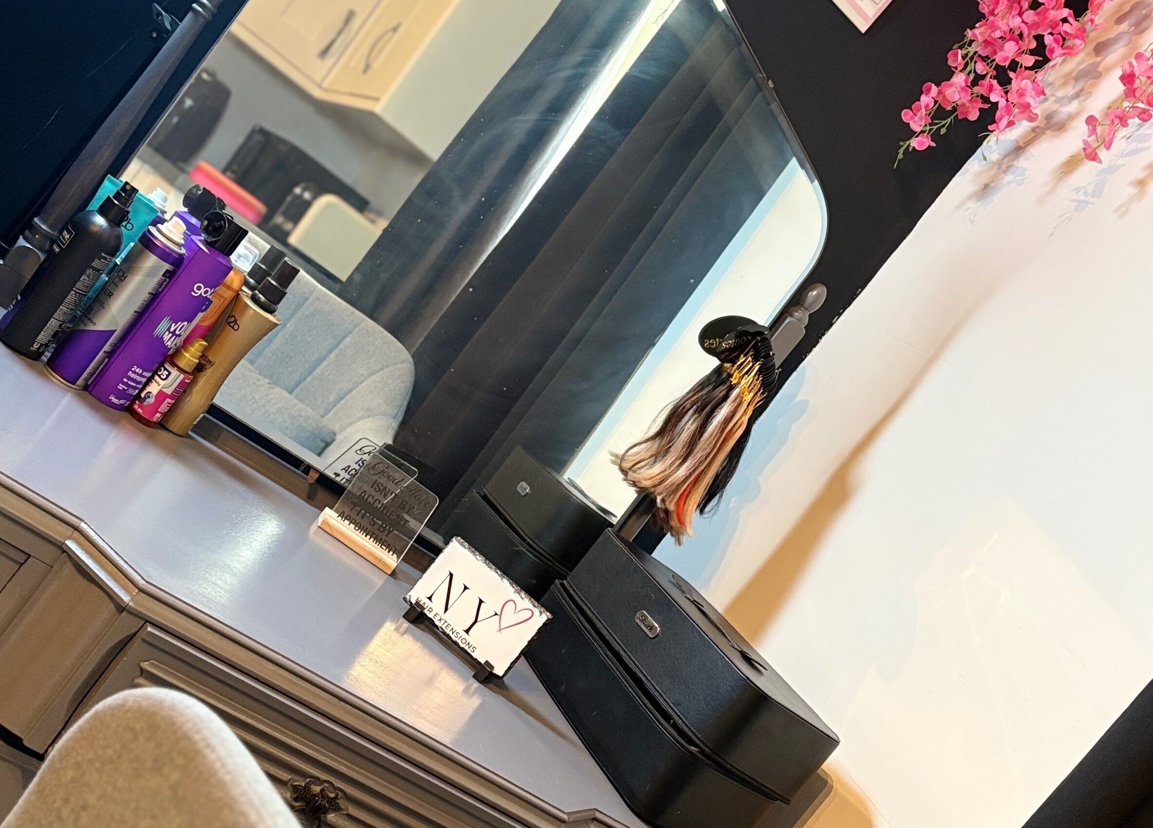 Elegant styling station at NYHairextensions, Carlisle, England, GB with beauty products and decor.