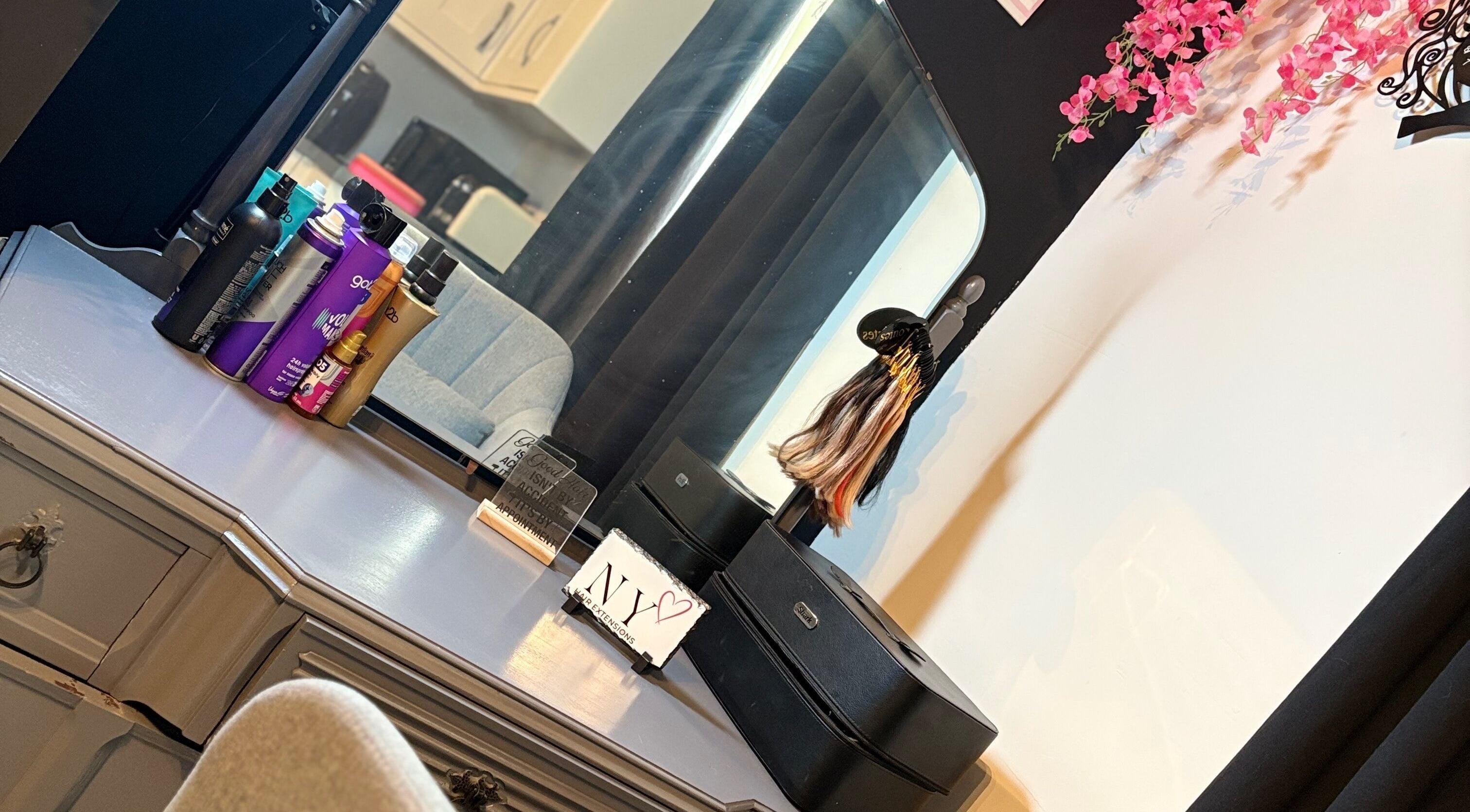 Elegant styling station at NYHairextensions, Carlisle, England, GB with beauty products and decor.