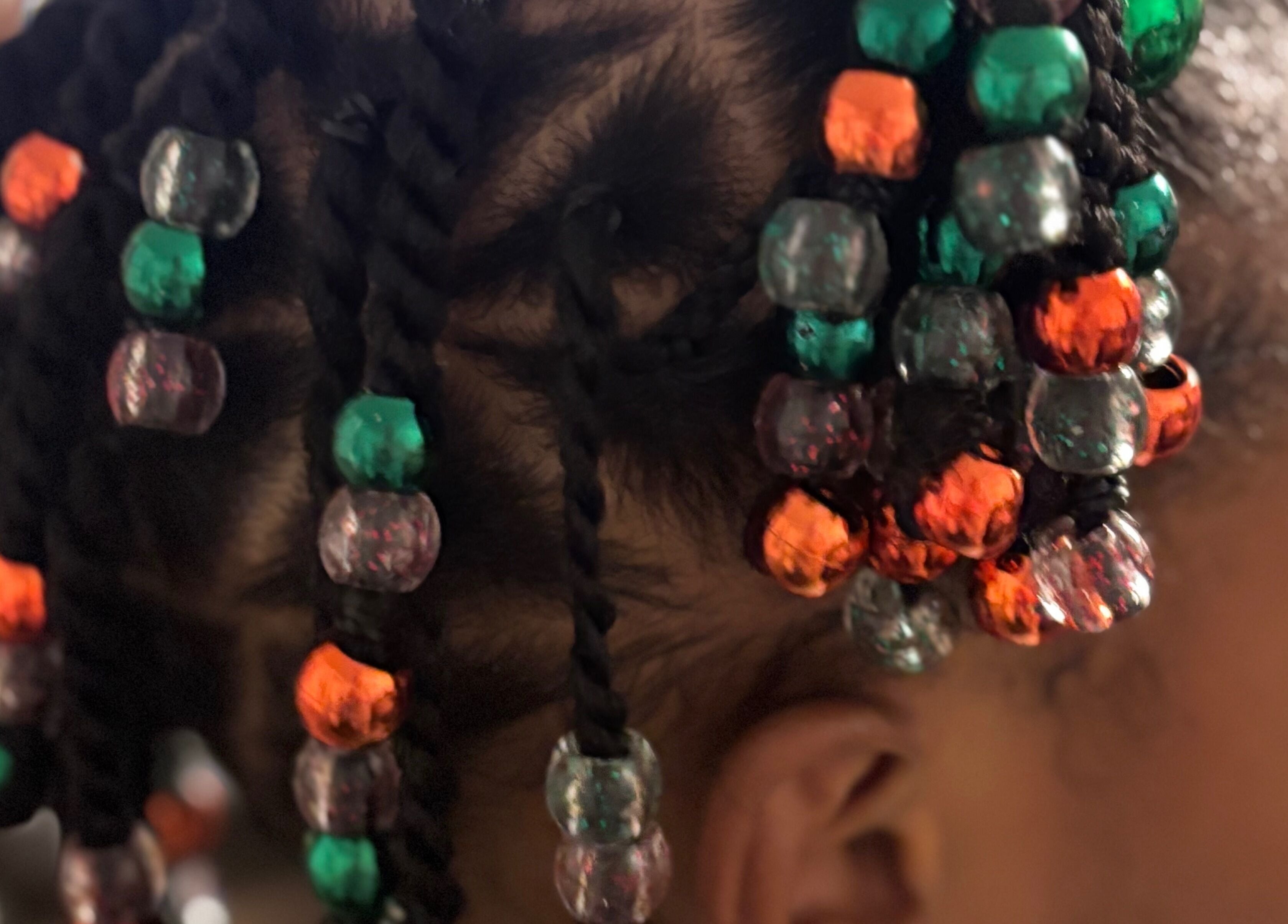 Close-up of colorful beaded braids at Hair Love by Taryn, Lakeland, Florida, US, showcasing creative hairstyle.