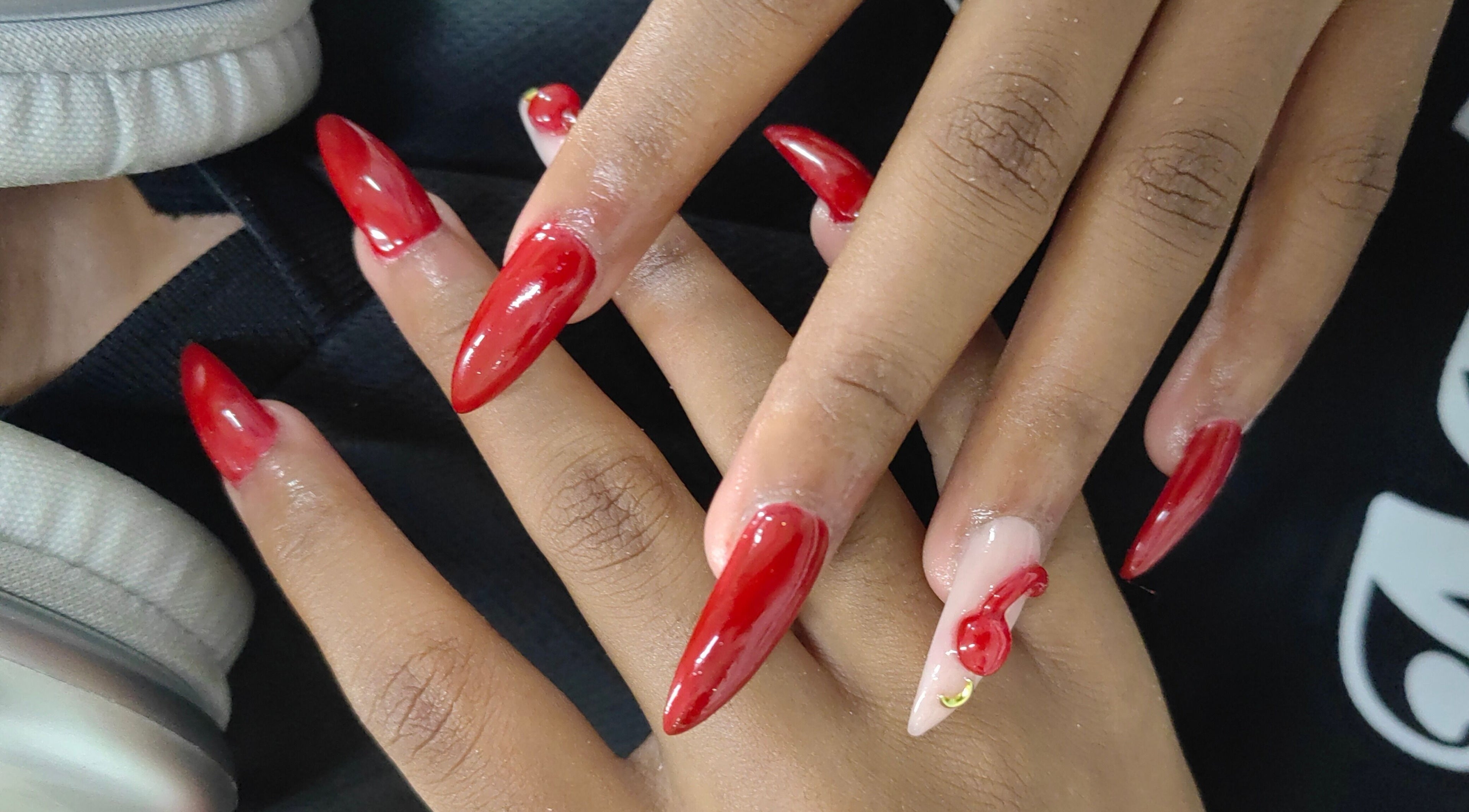 Stylish red manicure at The Beauty Booth in Bloemfontein, Free State, ZA. Elegantly shaped nails with glossy finish.