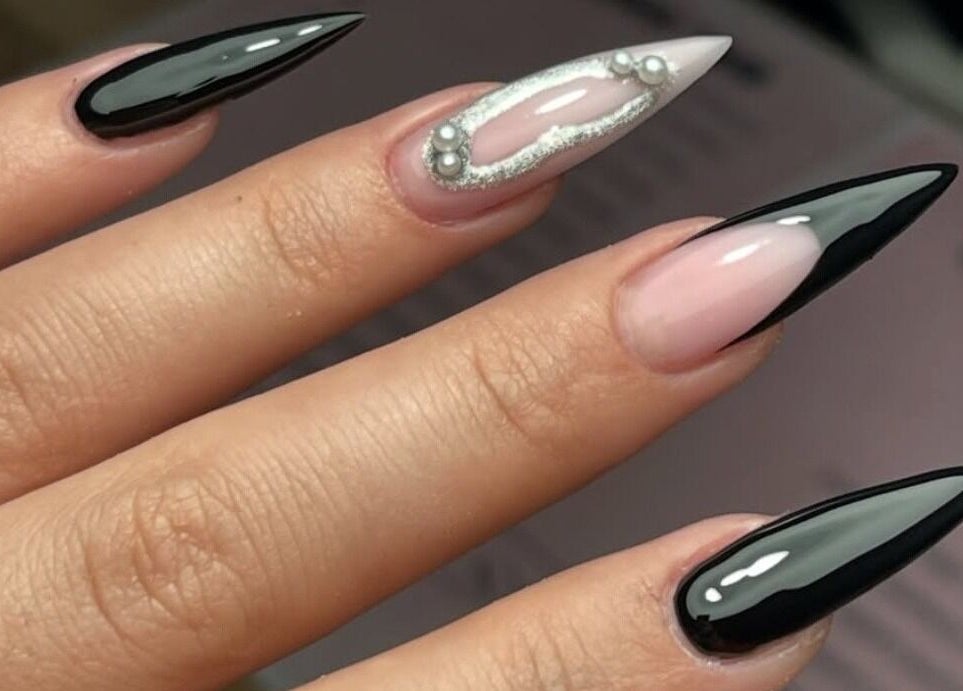 Elegant stiletto nails with black and pearl accents at The Beauty Booth, Bloemfontein, Free State, ZA.
