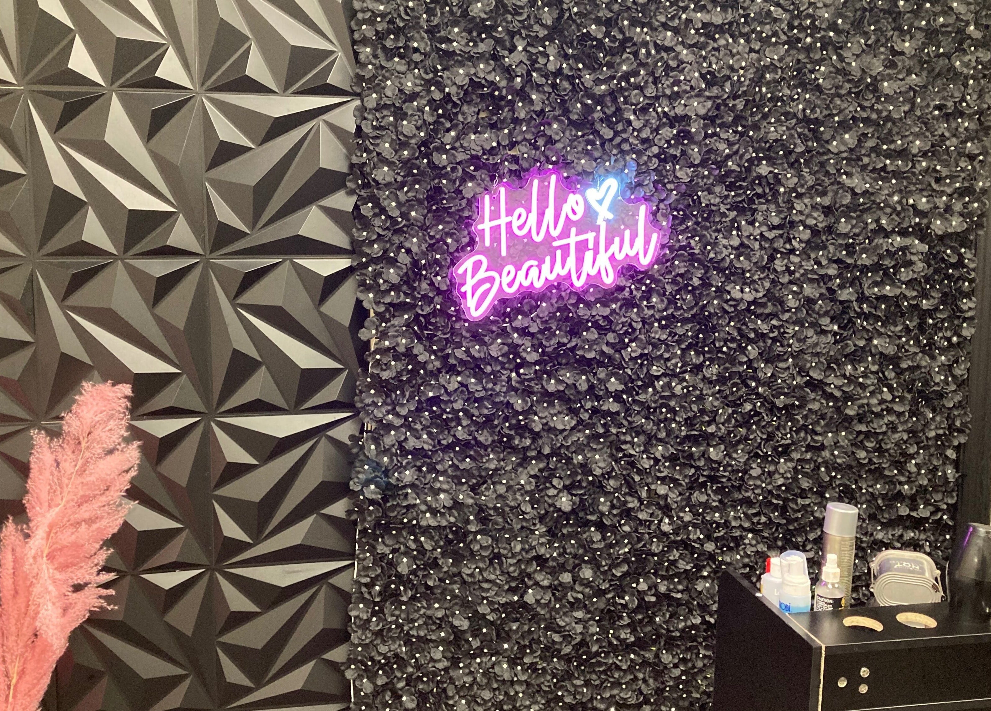 Hairfanaticboutique Llc in Columbia, South Carolina, US features a chic wall with 'Hello Beautiful' neon sign.