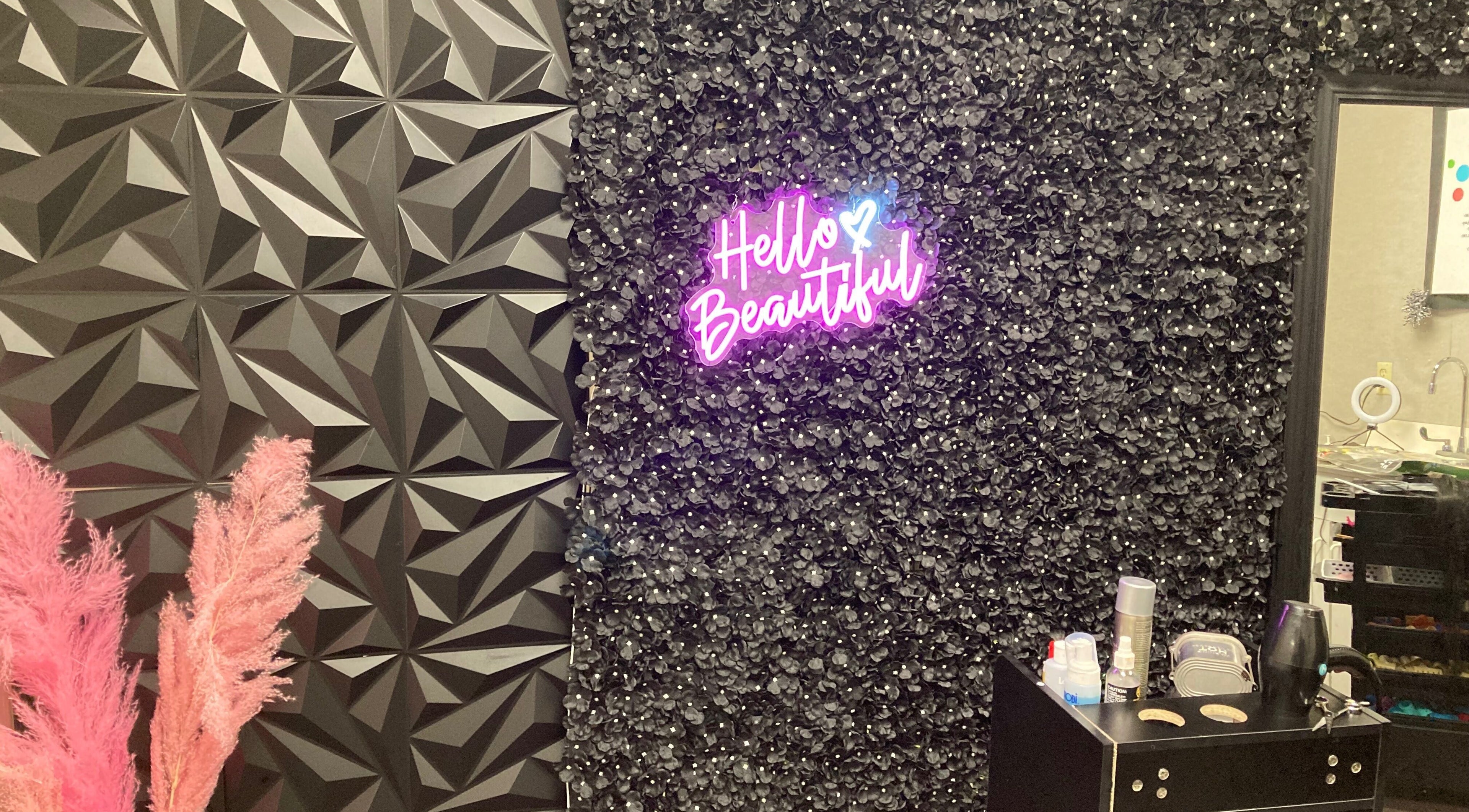 Hairfanaticboutique Llc in Columbia, South Carolina, US features a chic wall with 'Hello Beautiful' neon sign.