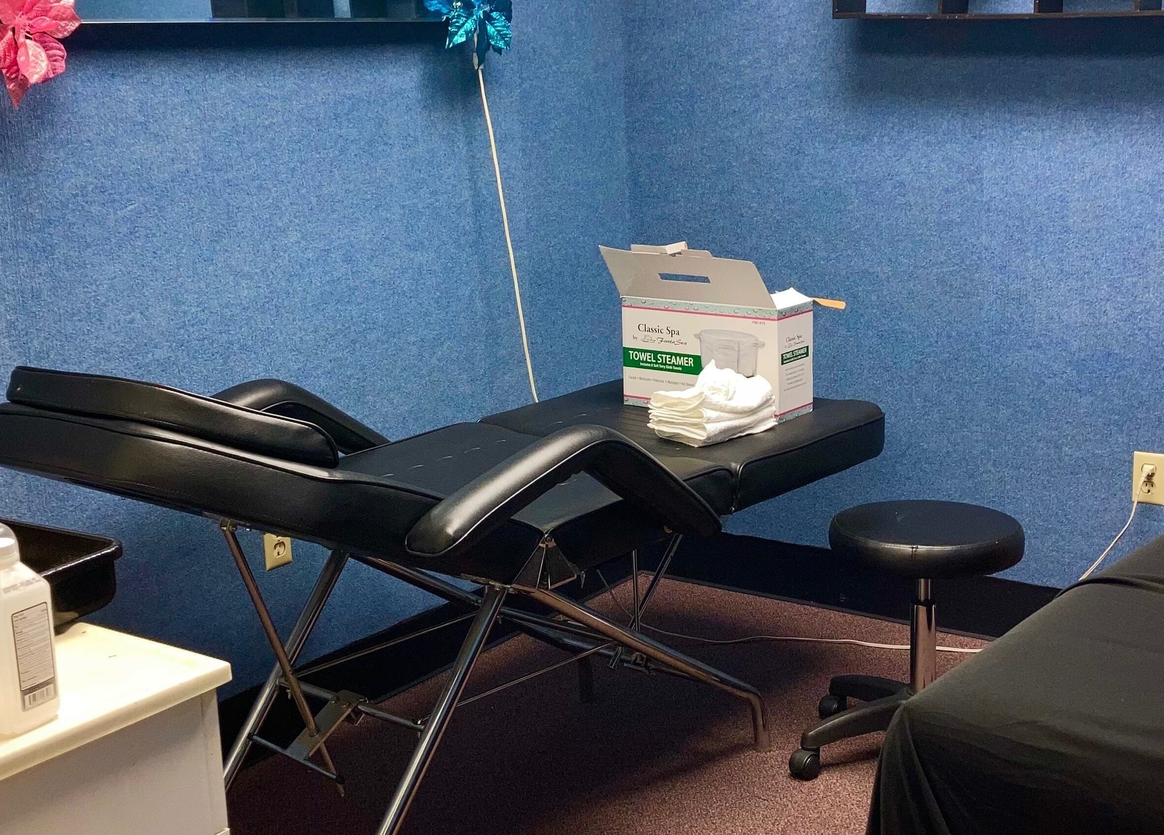 Relaxing spa treatment room at Hairfanaticboutique Llc, Columbia, South Carolina, US, showcasing comfy massage table.